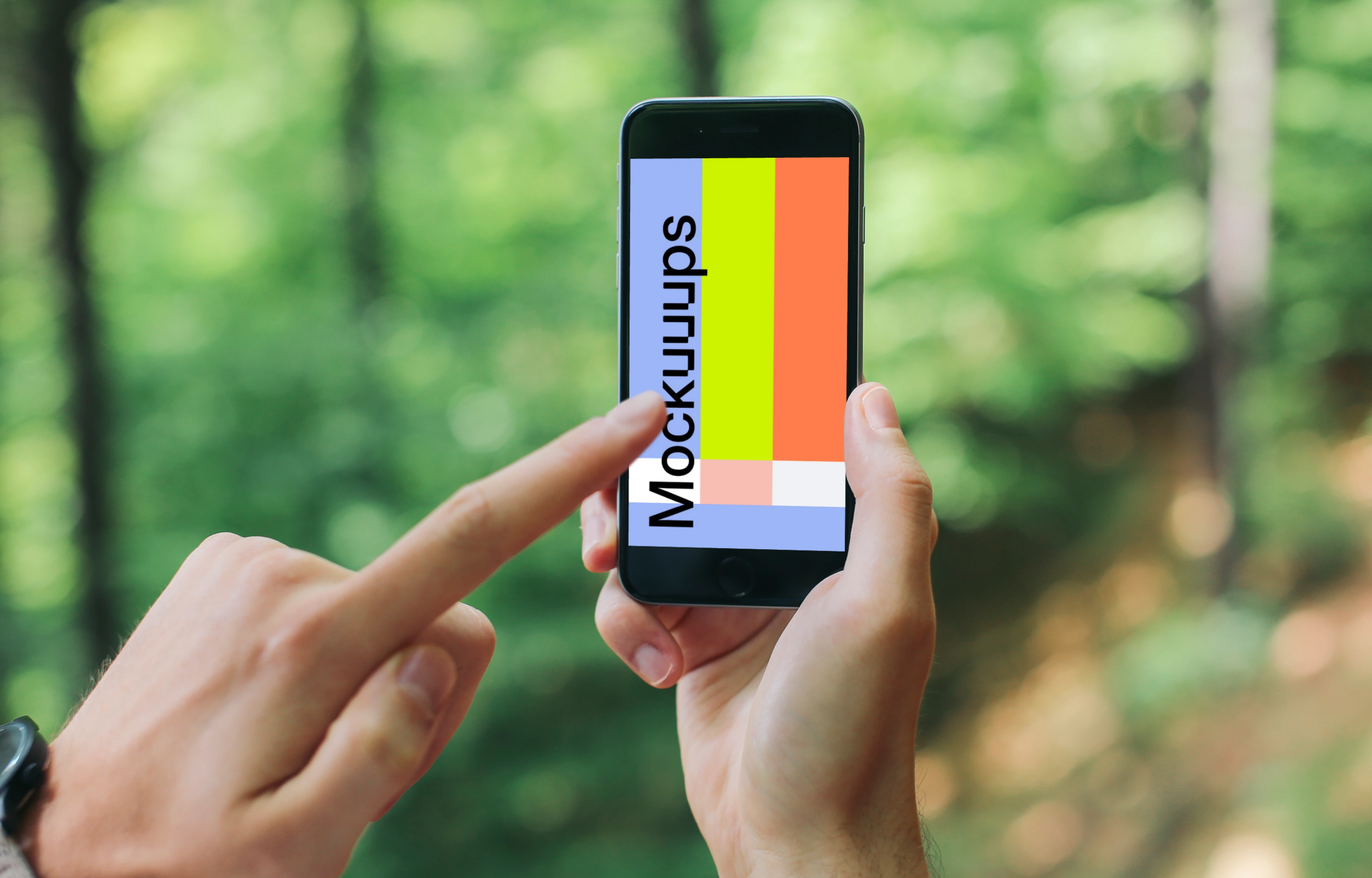 Pointing on iPhone 6 mockup in the forest