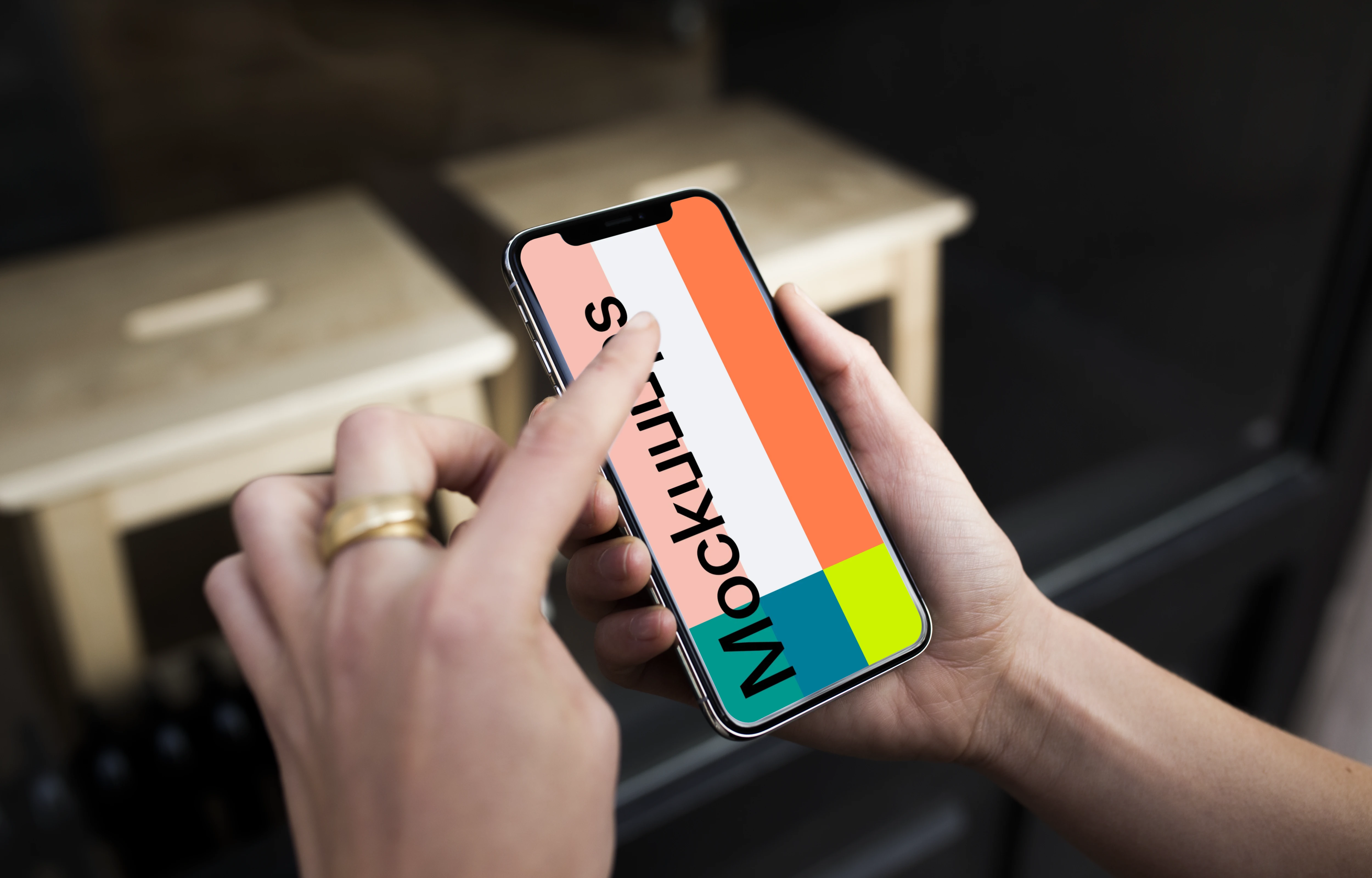 Pointing on iPhone X mockup in front of the shop