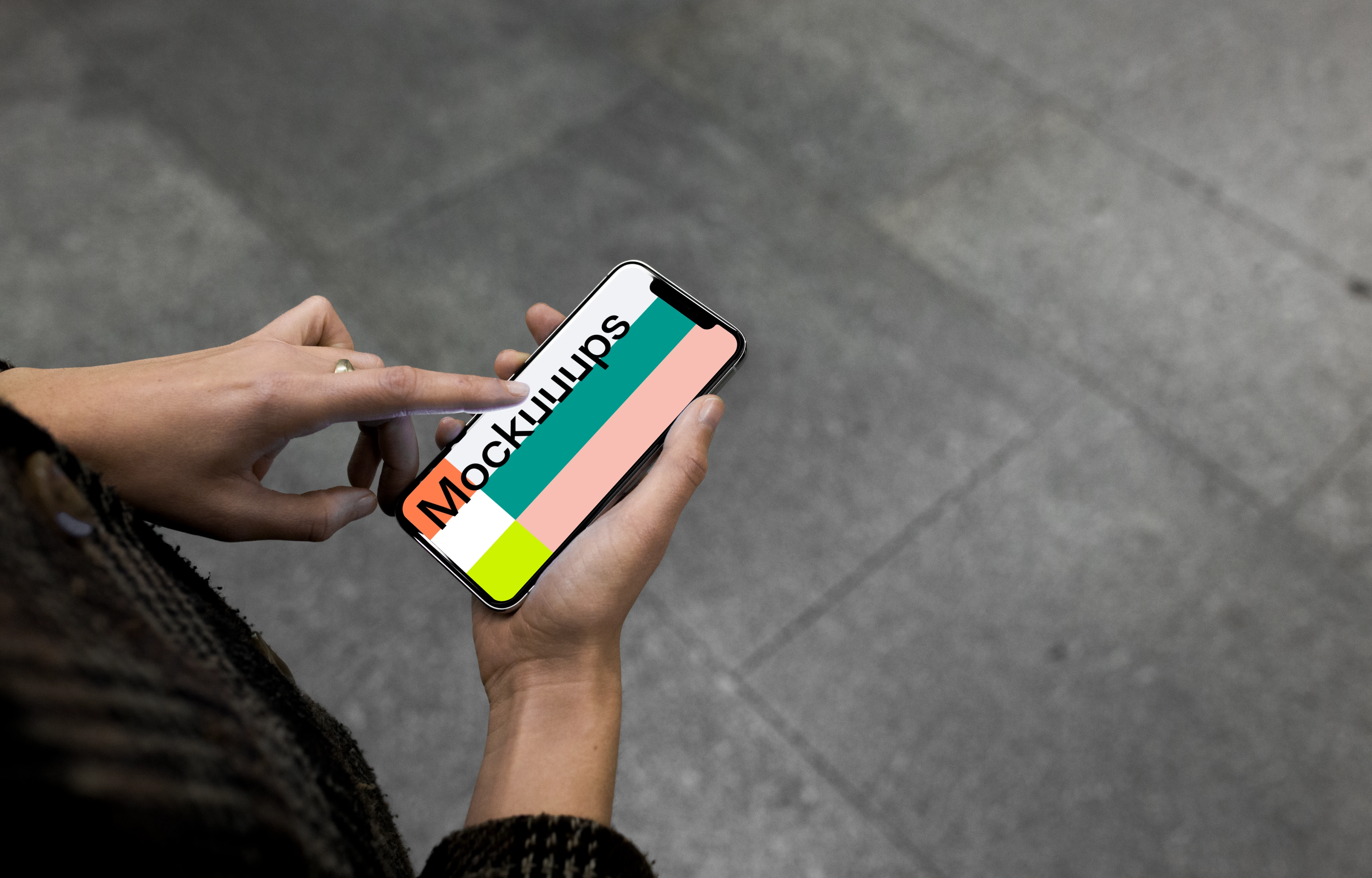 Pointing on iPhone X mockup in the underground