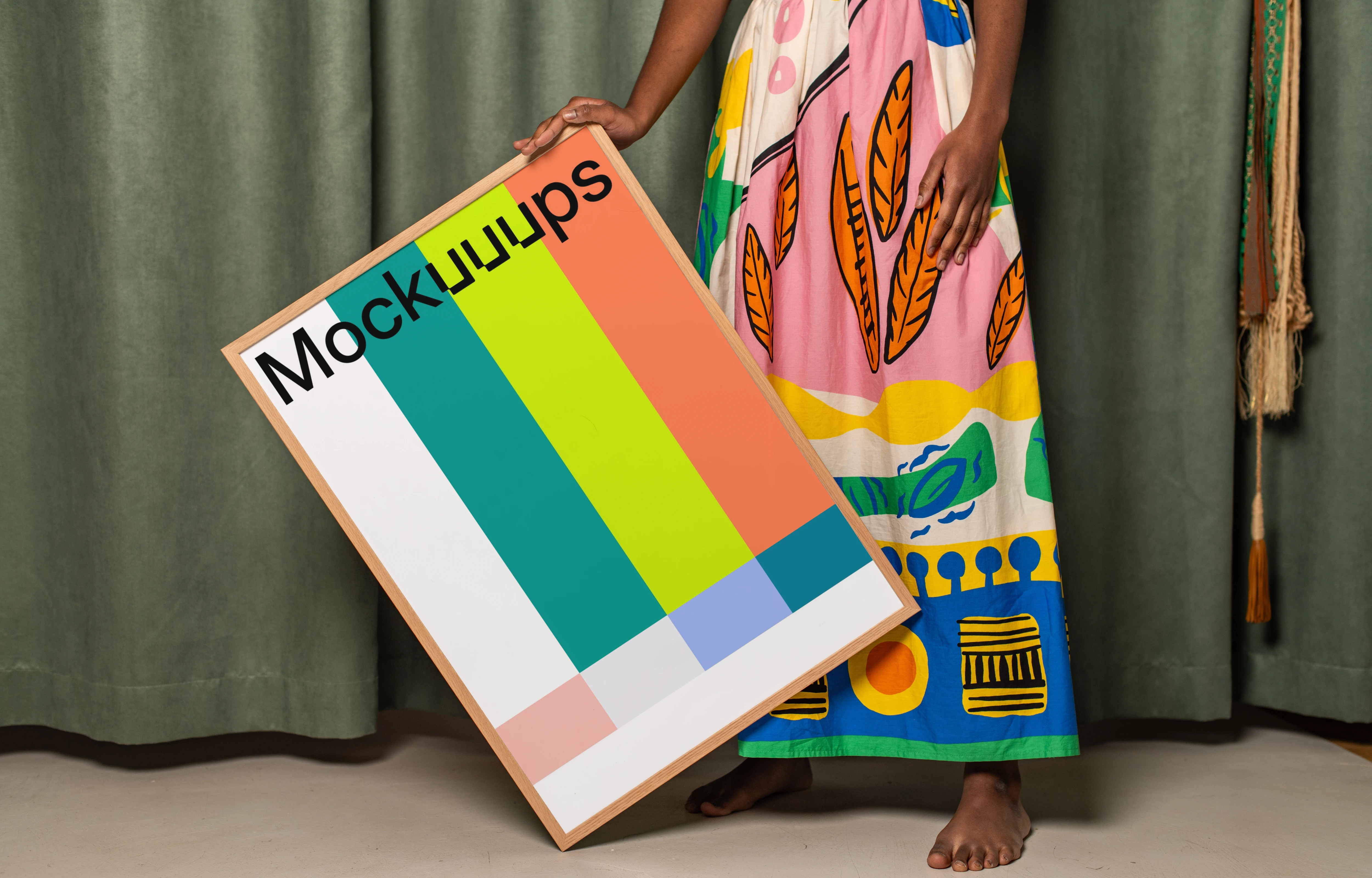 Poster mockup held against a colorful fabric backdrop