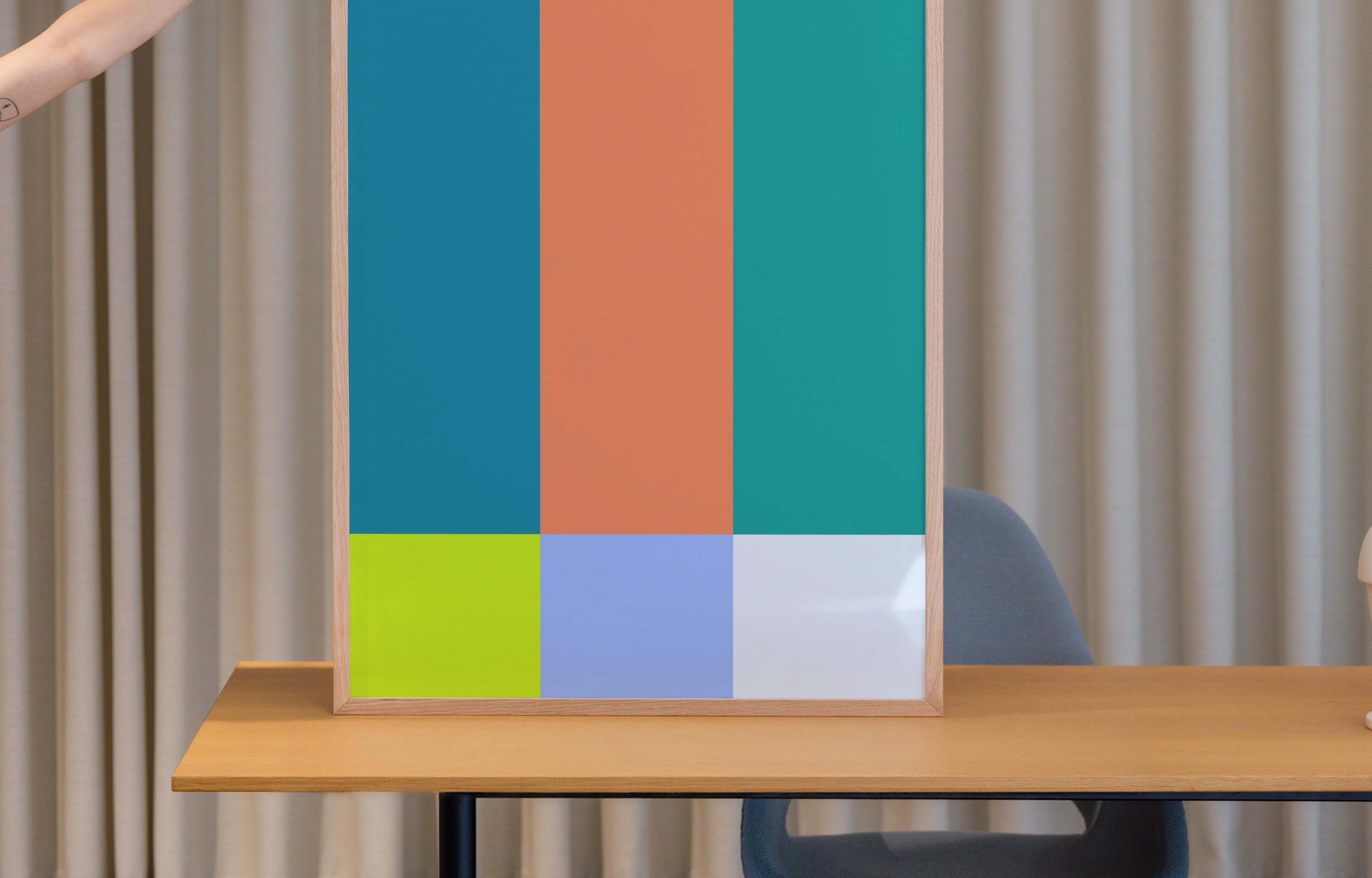 Poster mockup on a wooden desk with neutral background