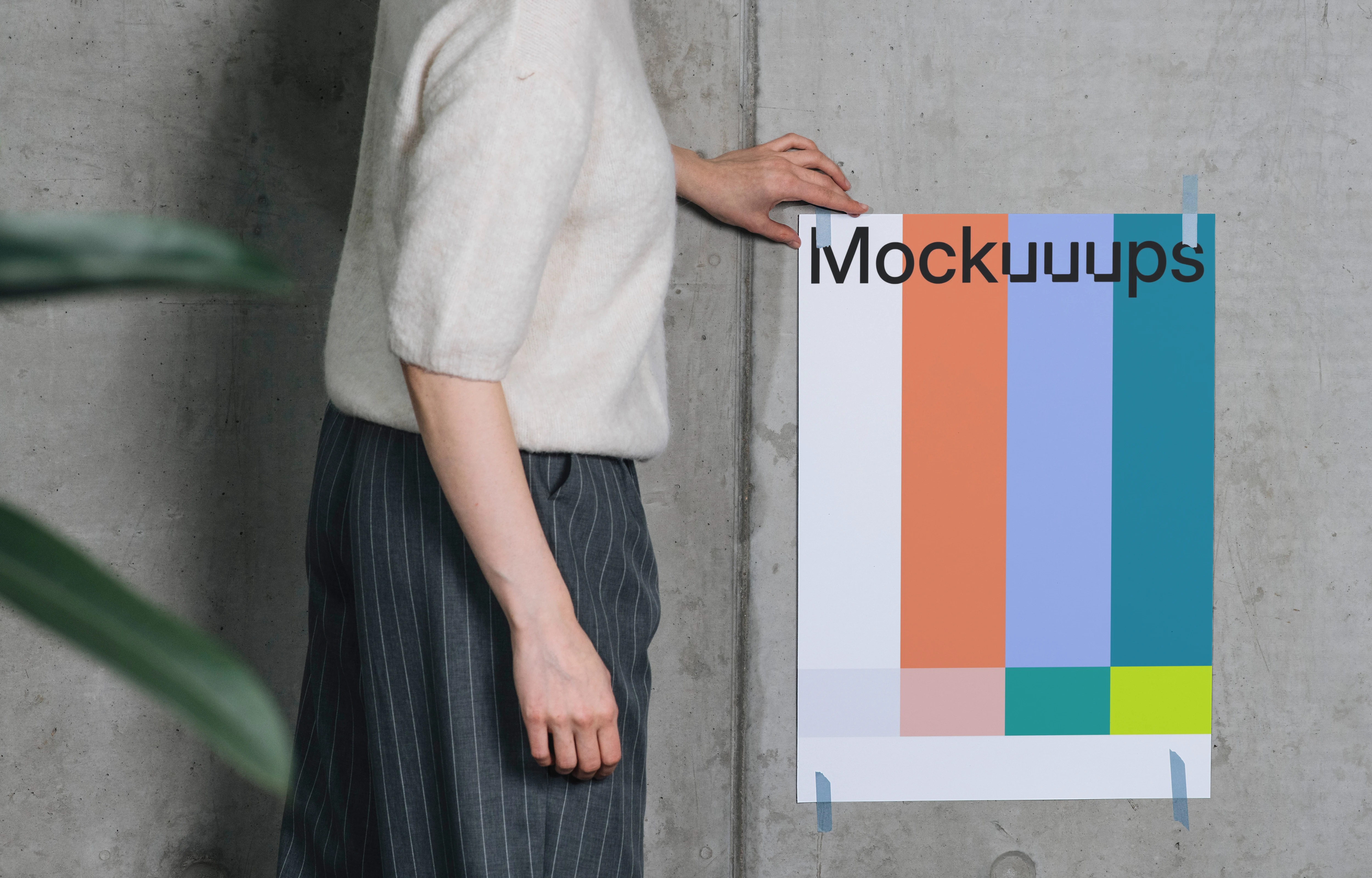 Poster mockup taped to a concrete wall with person