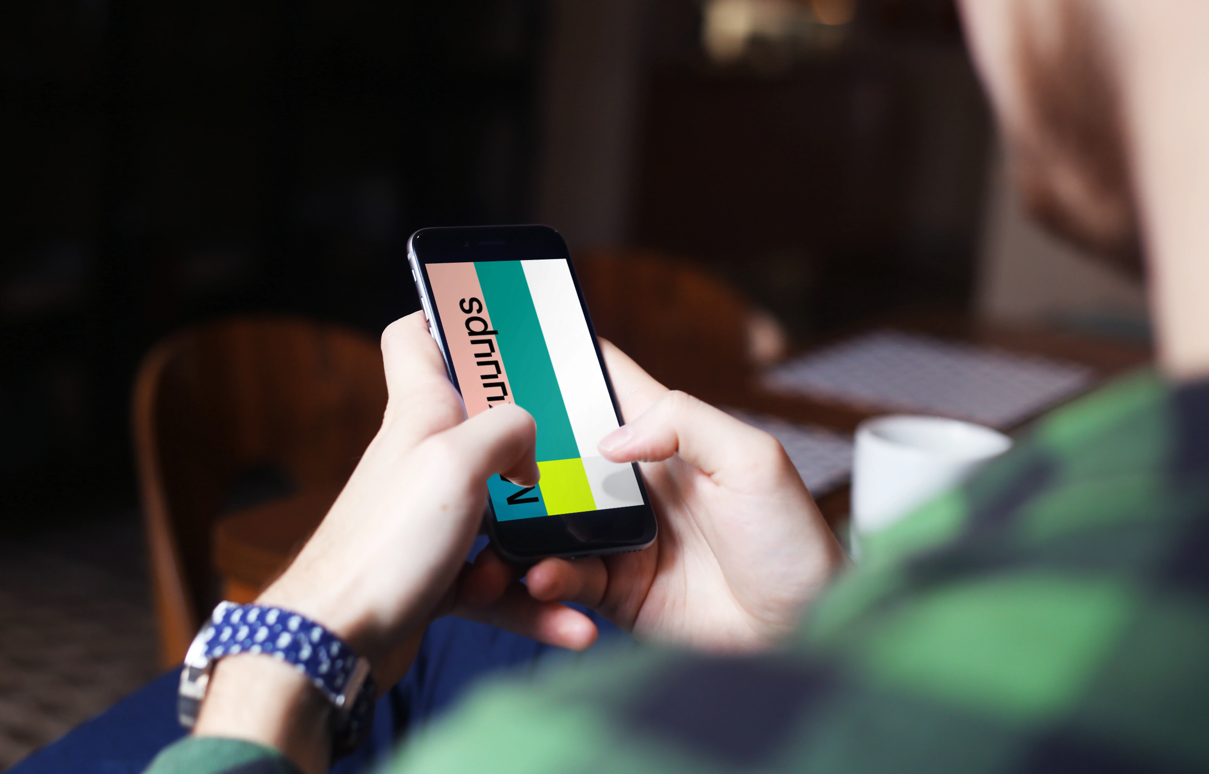 Typing on iPhone 6 mockup screen at coffee