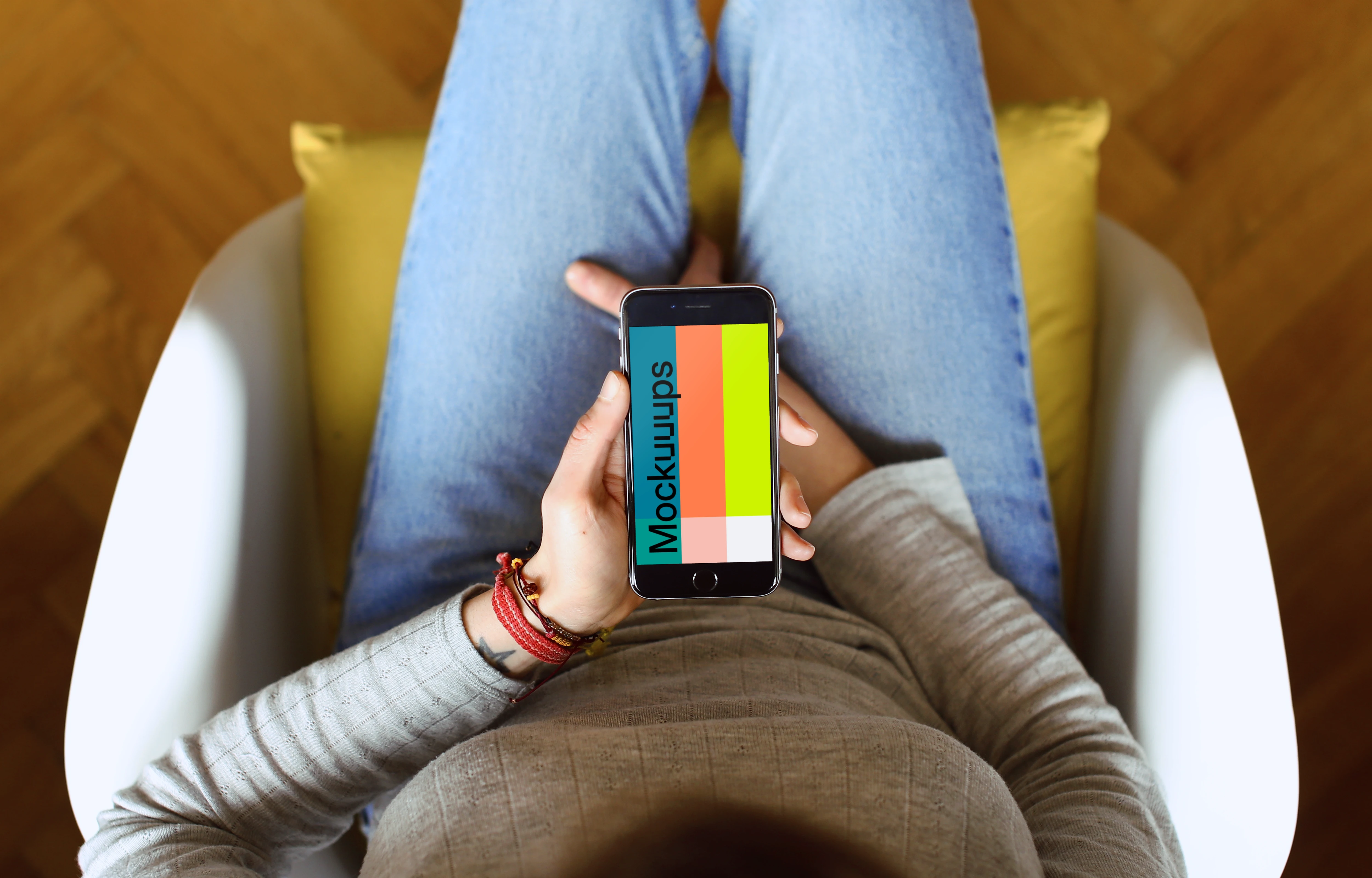 Sitting on the chair with iPhone 6s mockup