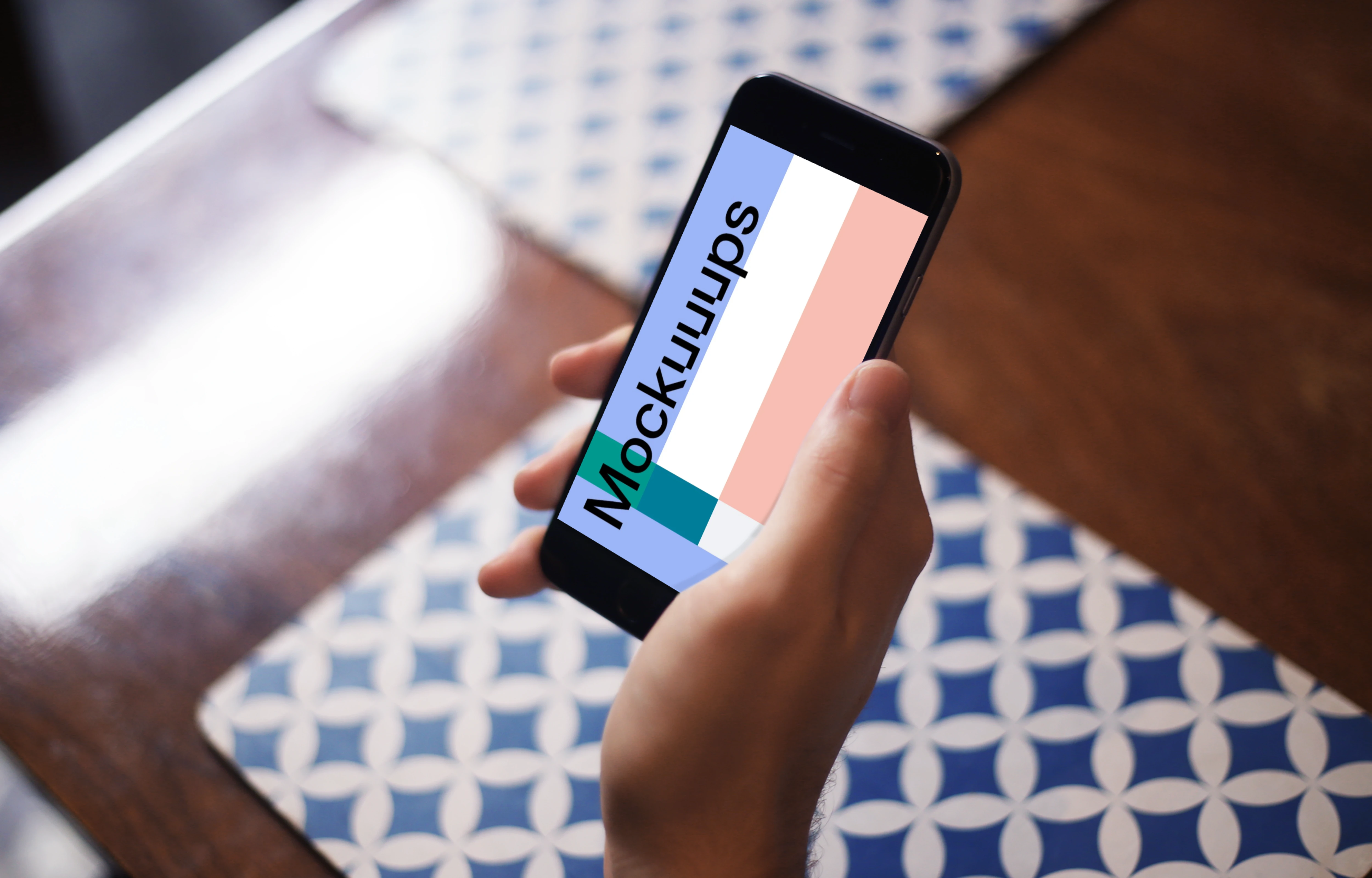 Sitting with iPhone 6 mockup at coffee