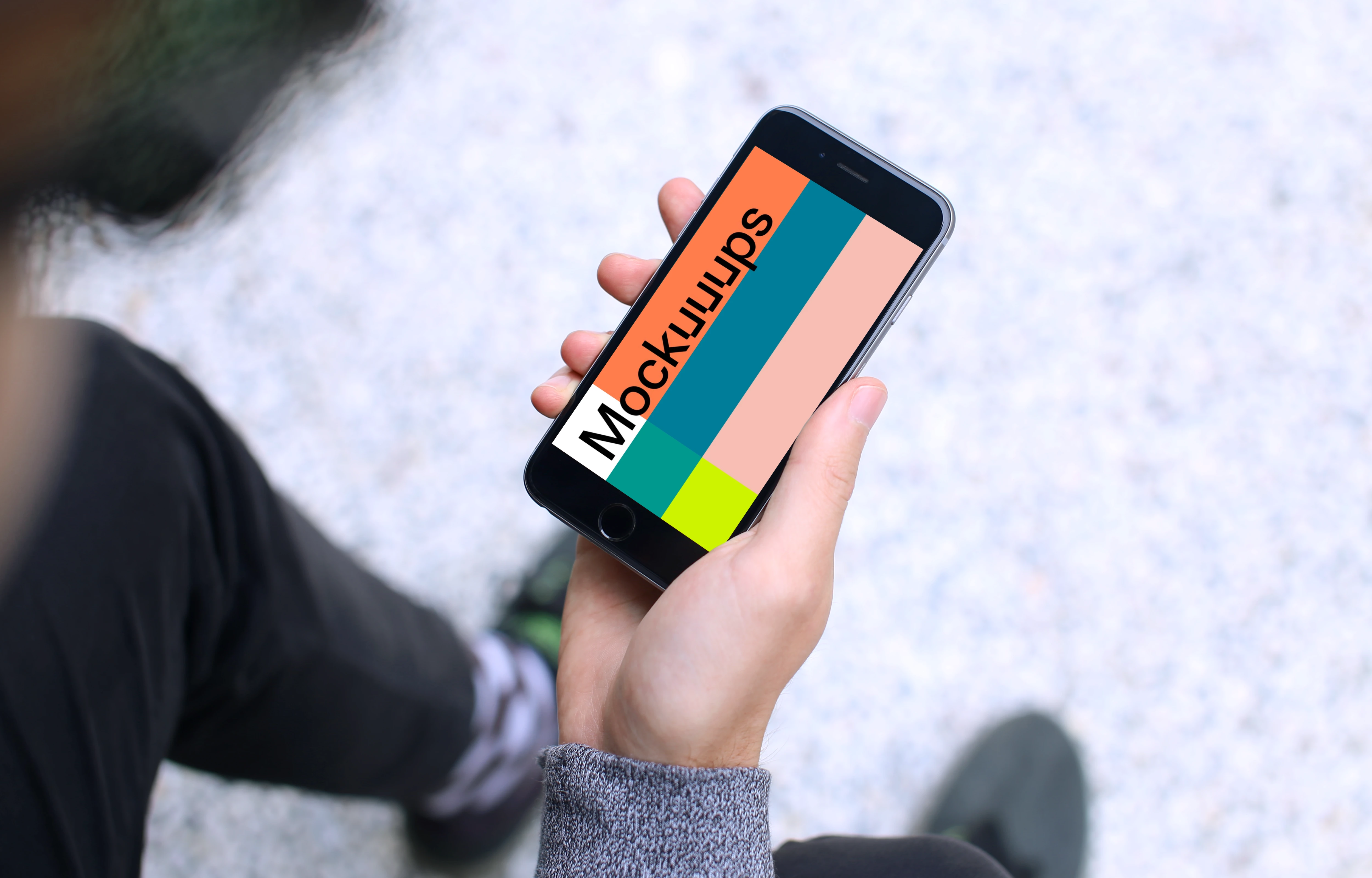 Sitting with iPhone 6s mockup Space Gray