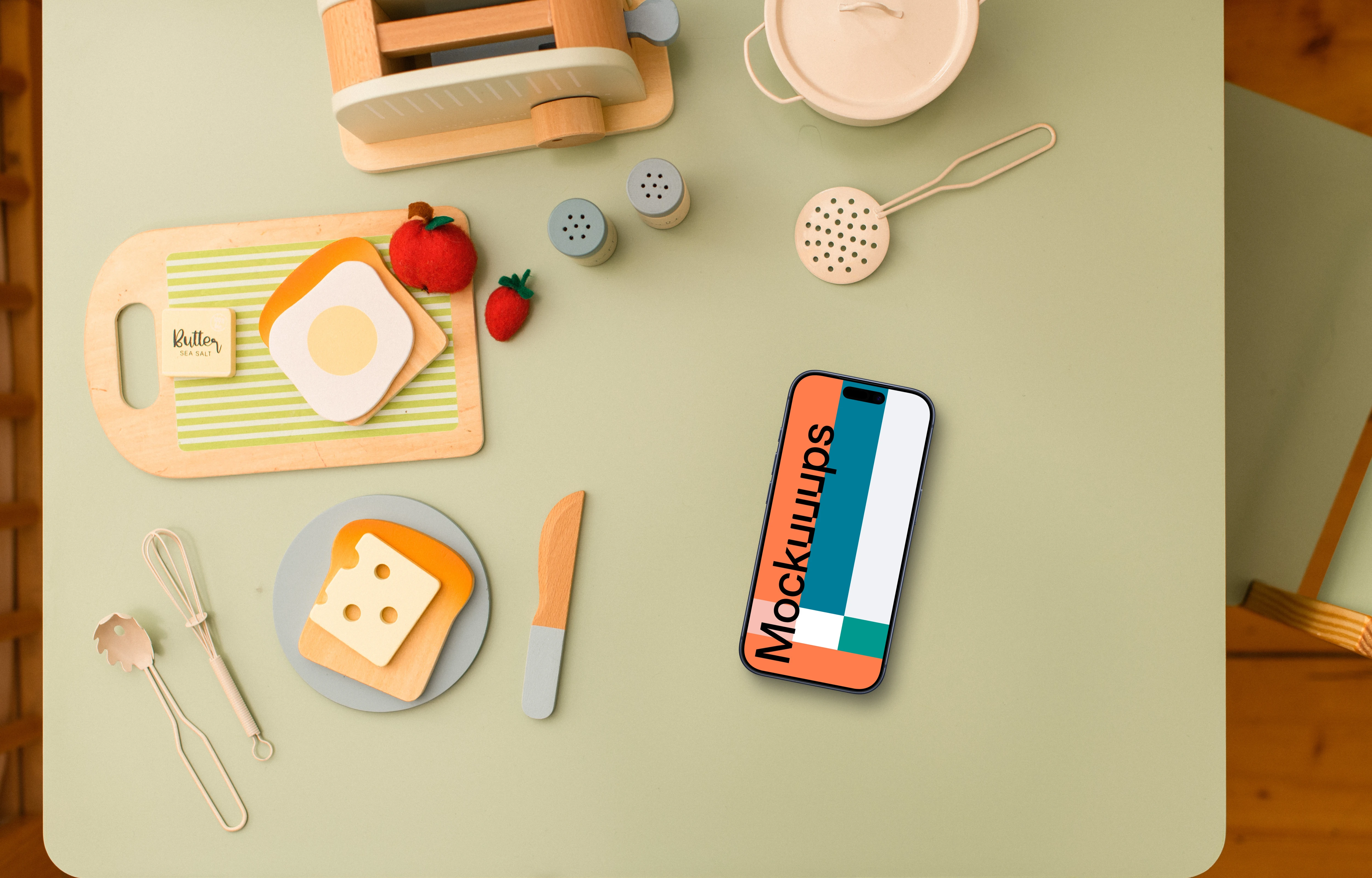 Smartphone mockup with children's play kitchen accessories