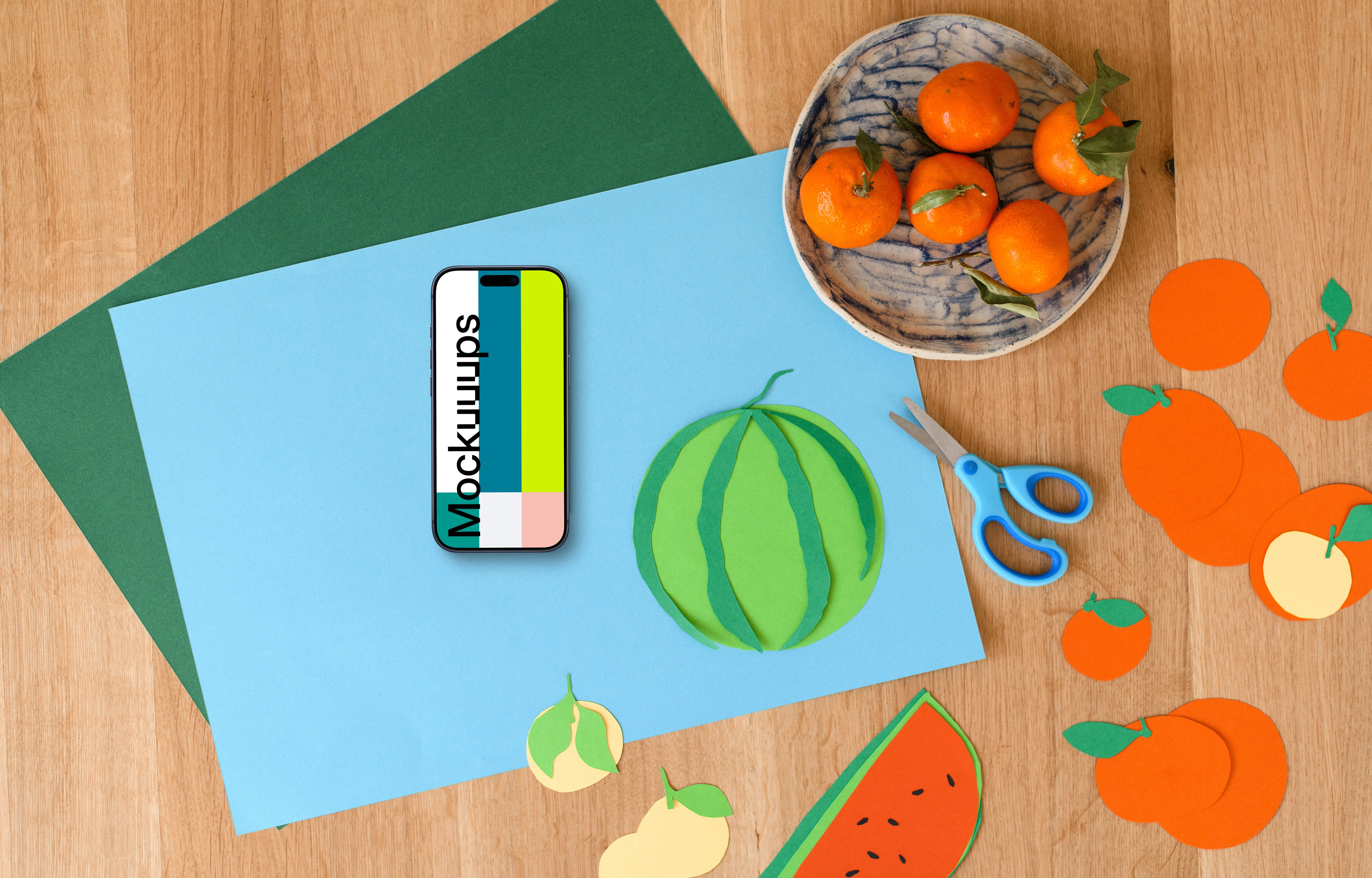 Smartphone mockup with colorful paper fruits on wooden surface