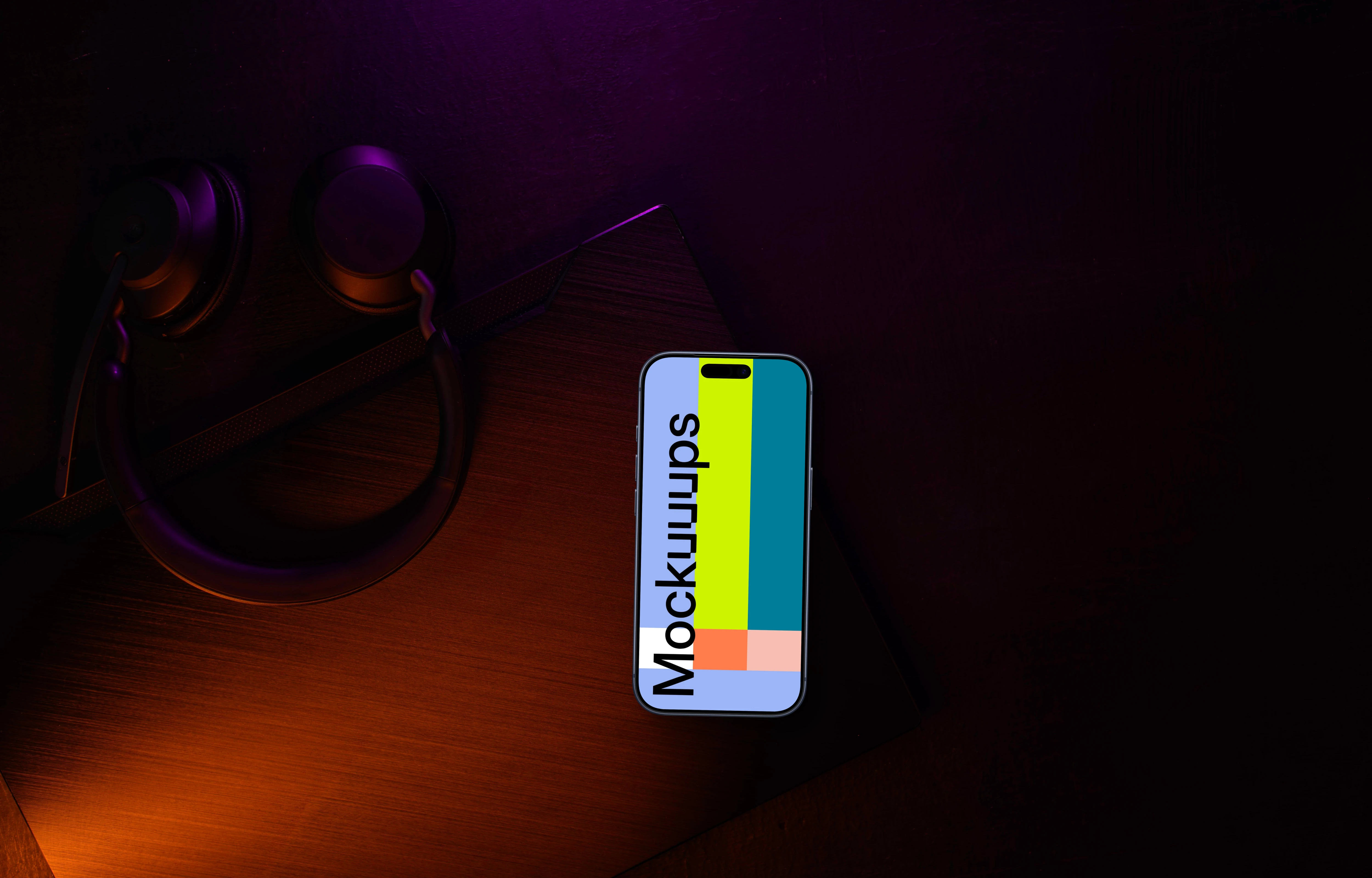 Smartphone mockup with headphones on dark desk