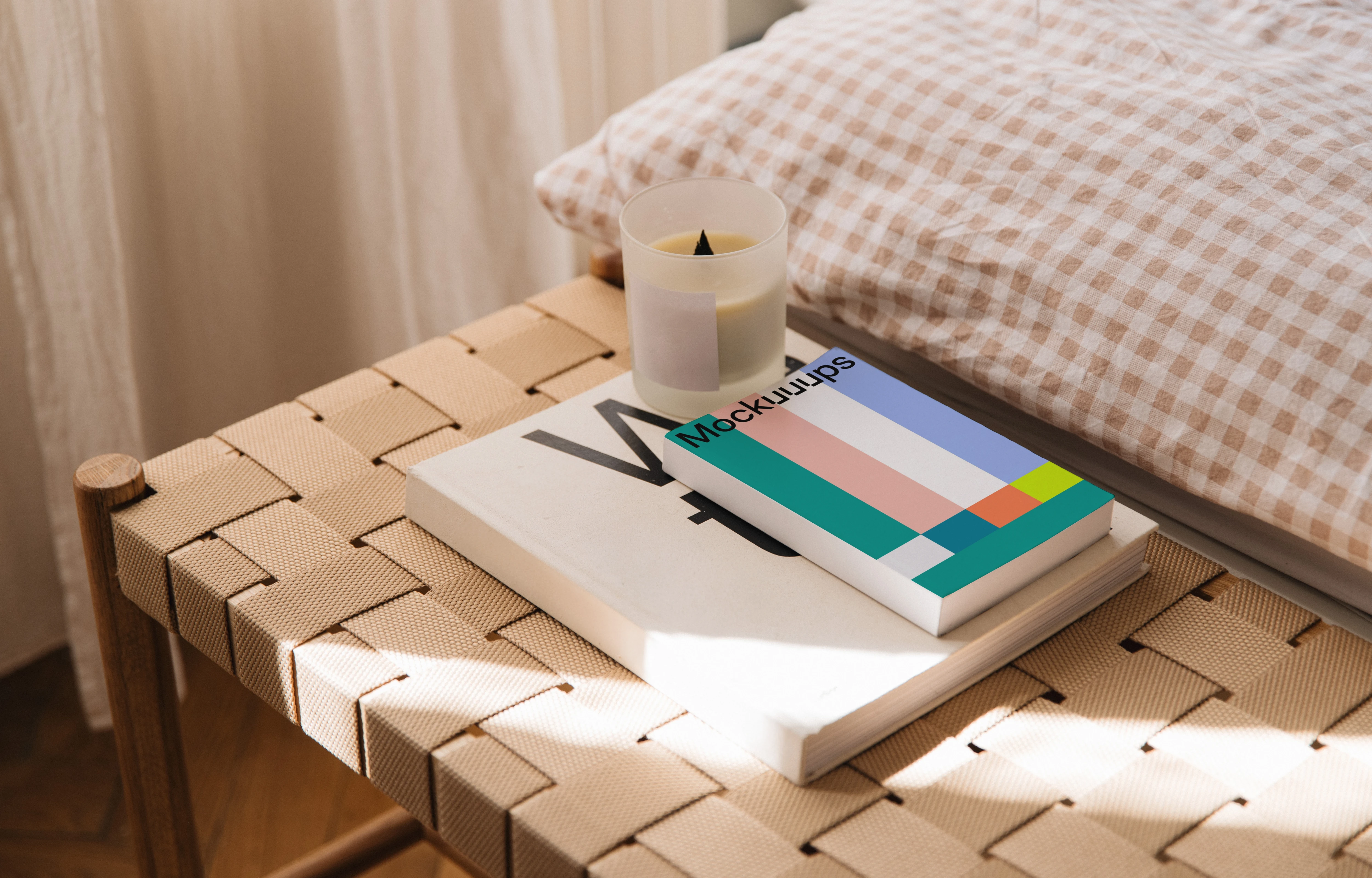Softcover book mockup on a woven bench in natural light