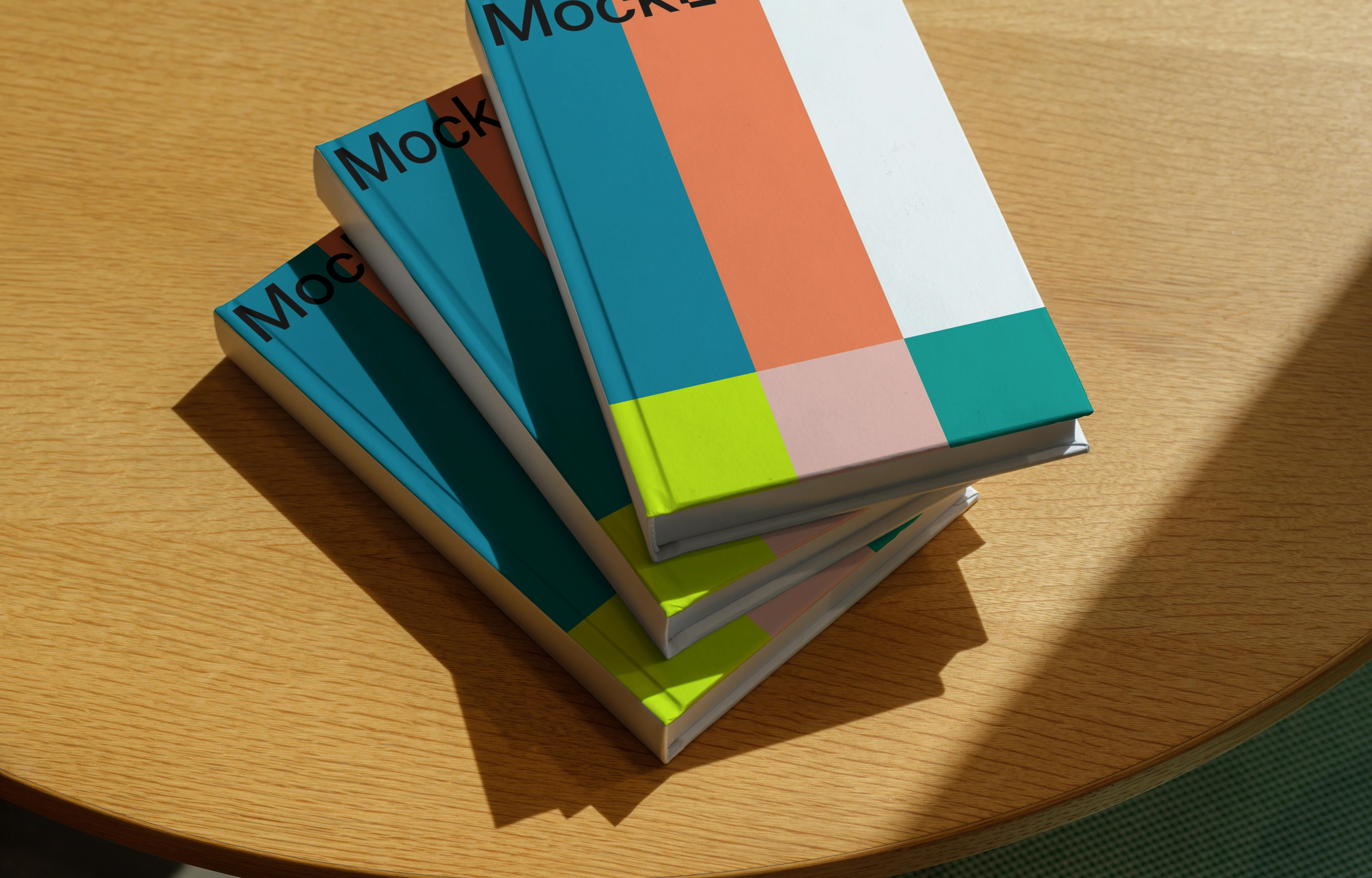 Stacked B-format book mockup on a sunlit wooden table