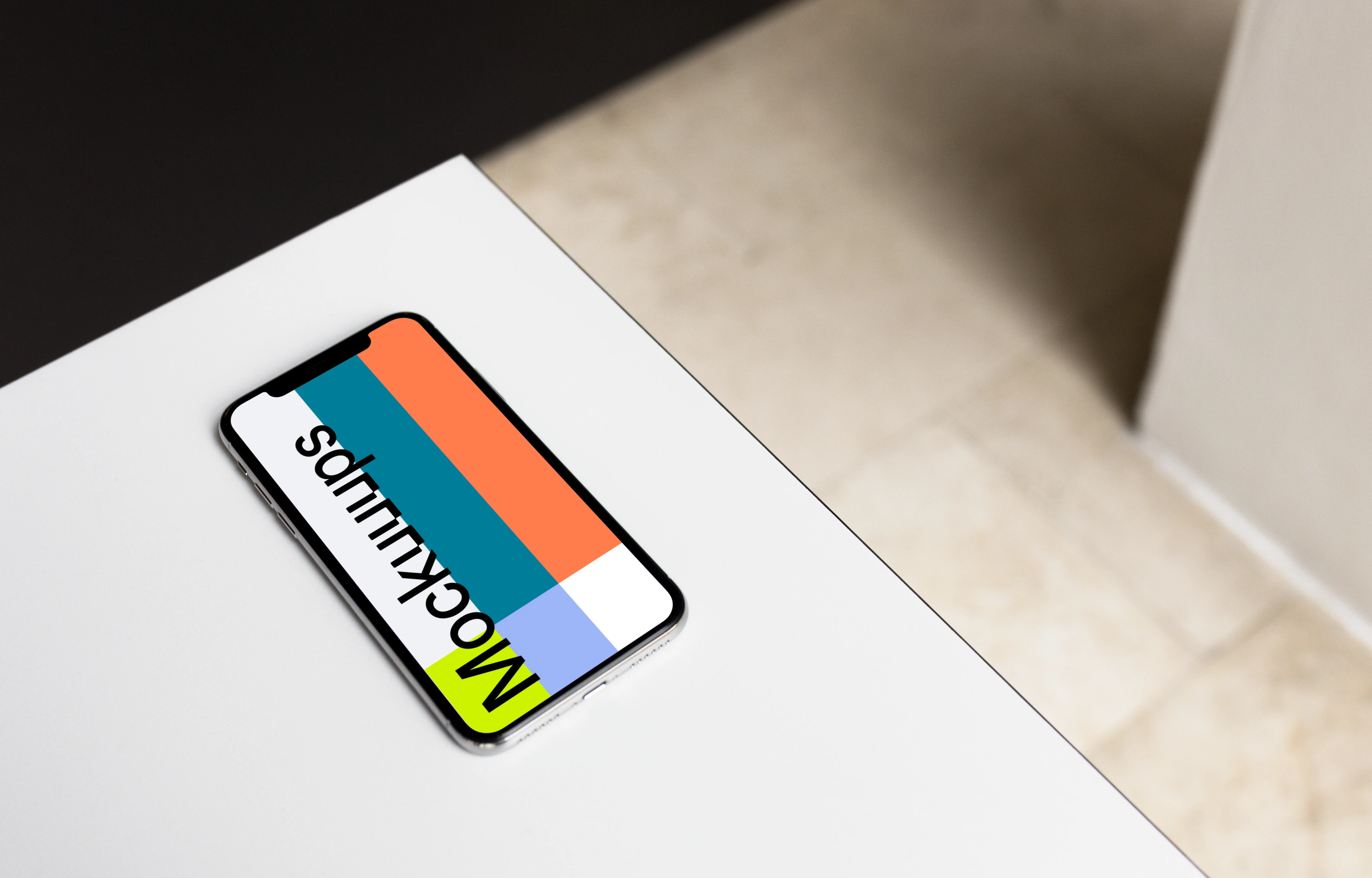 iPhone X mockup on the gray table
