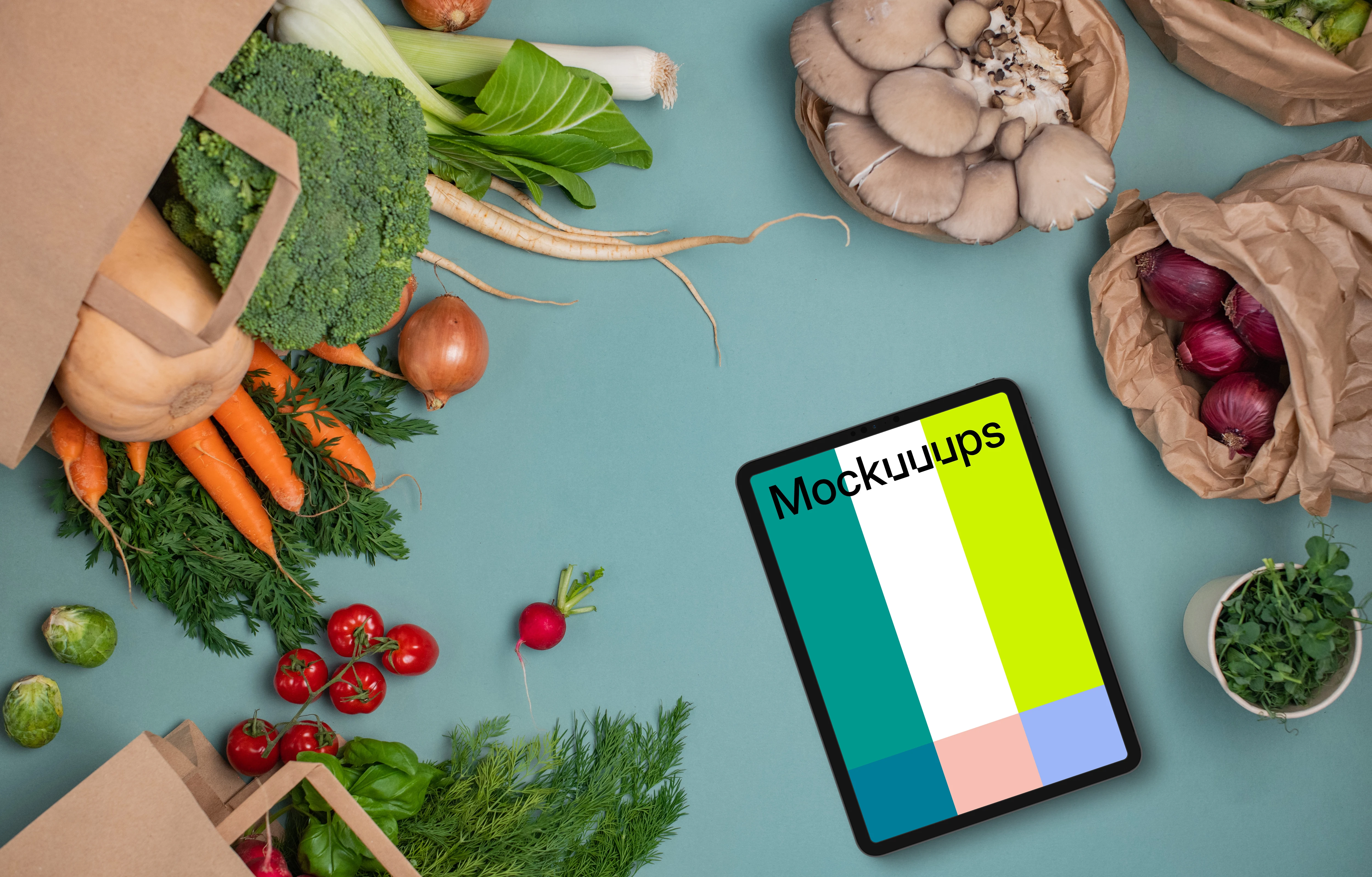 Tablet mockup between bags full of vegetables