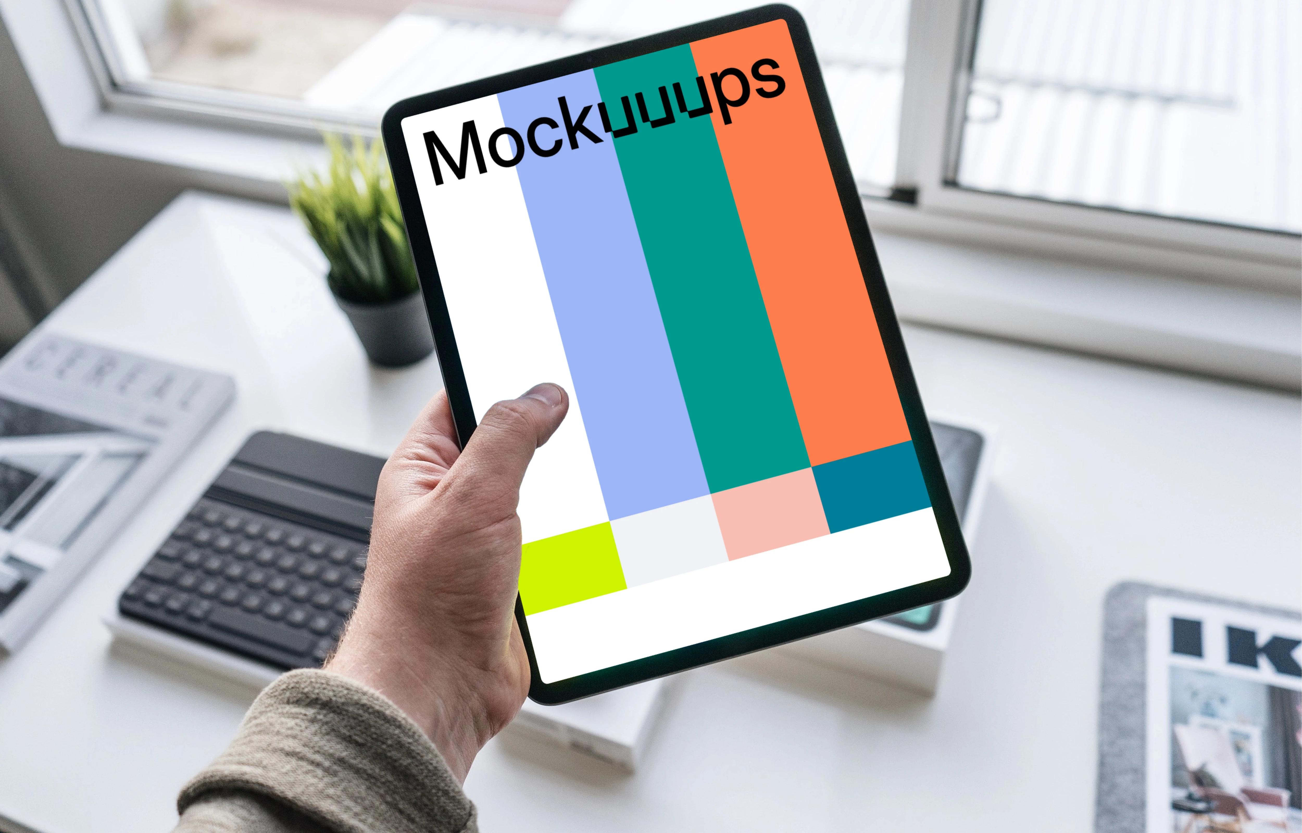 Tablet mockup held by man over work desk 
