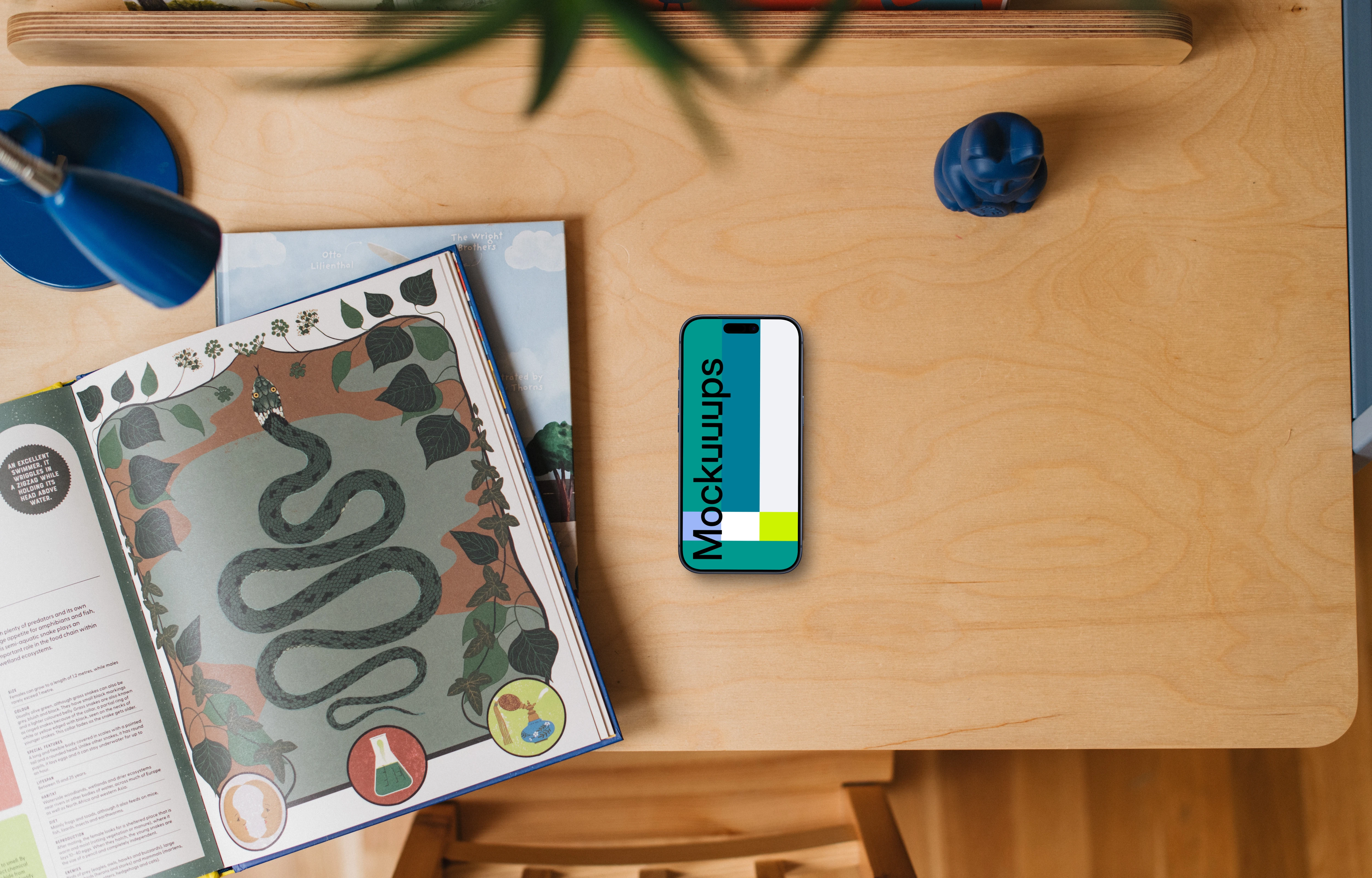 Children's book and smartphone mockup on wooden table