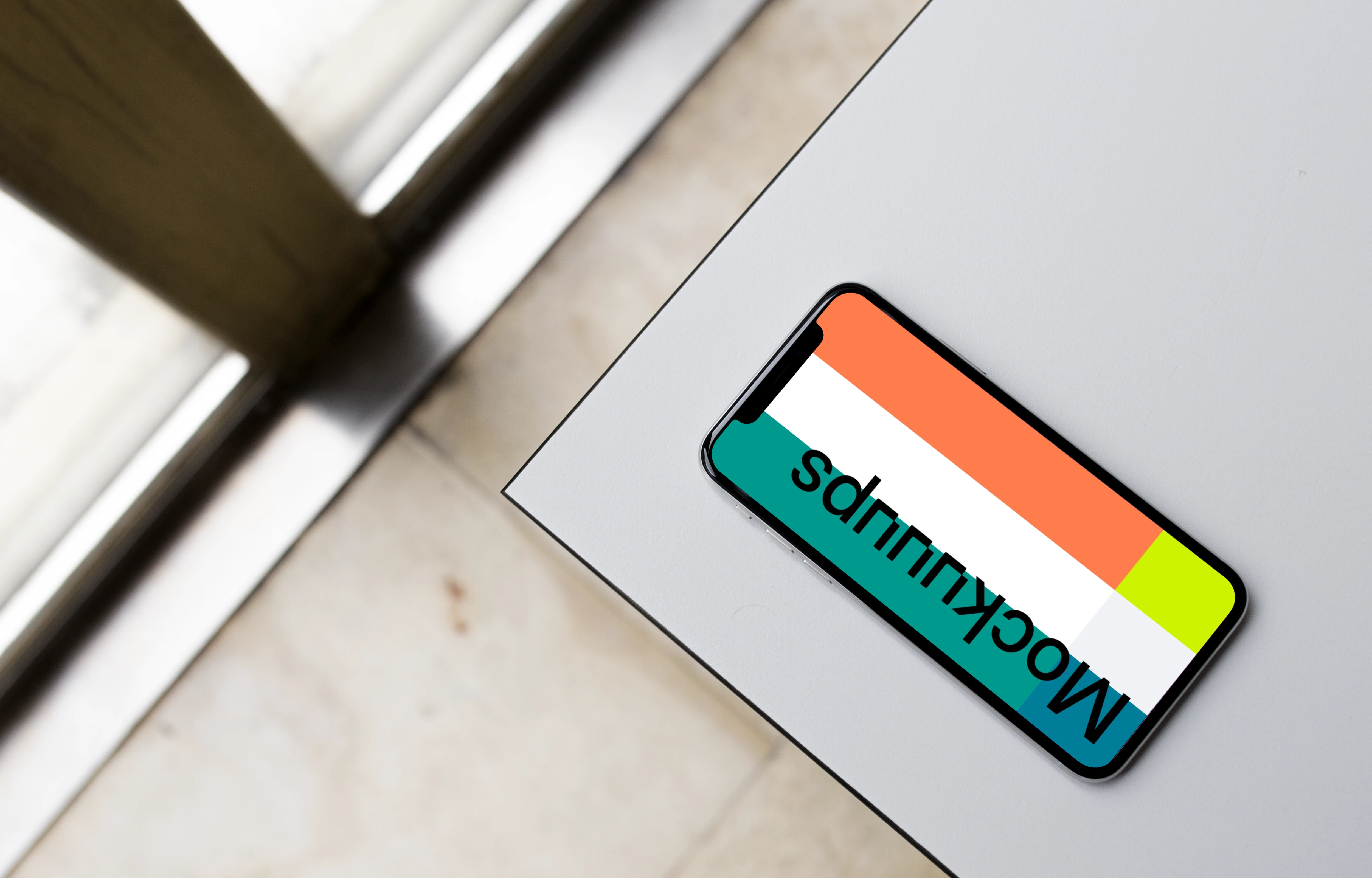 Top view mockup of iPhone X on the gray table