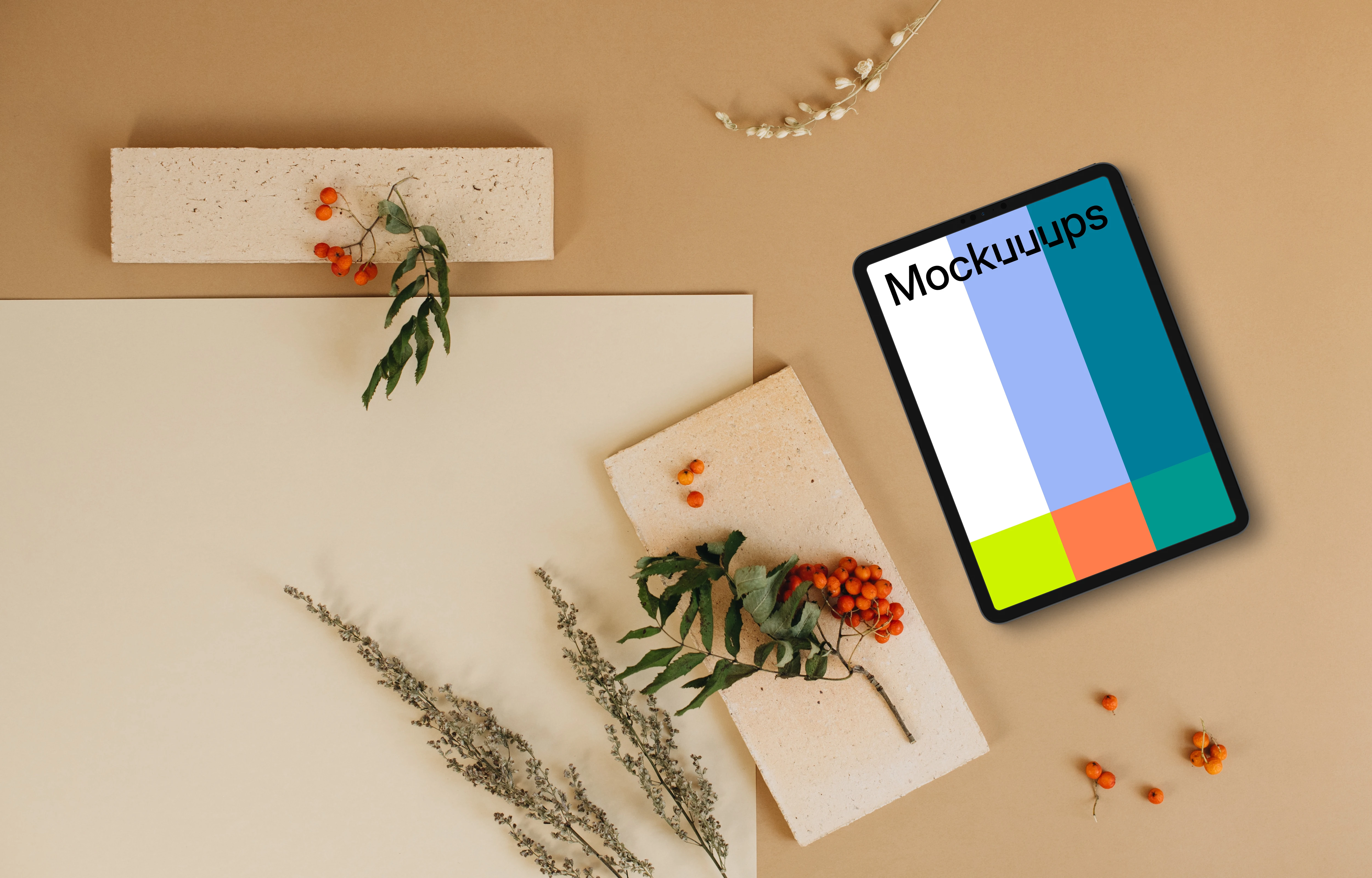 Top view of tablet mockup next to the blank paper