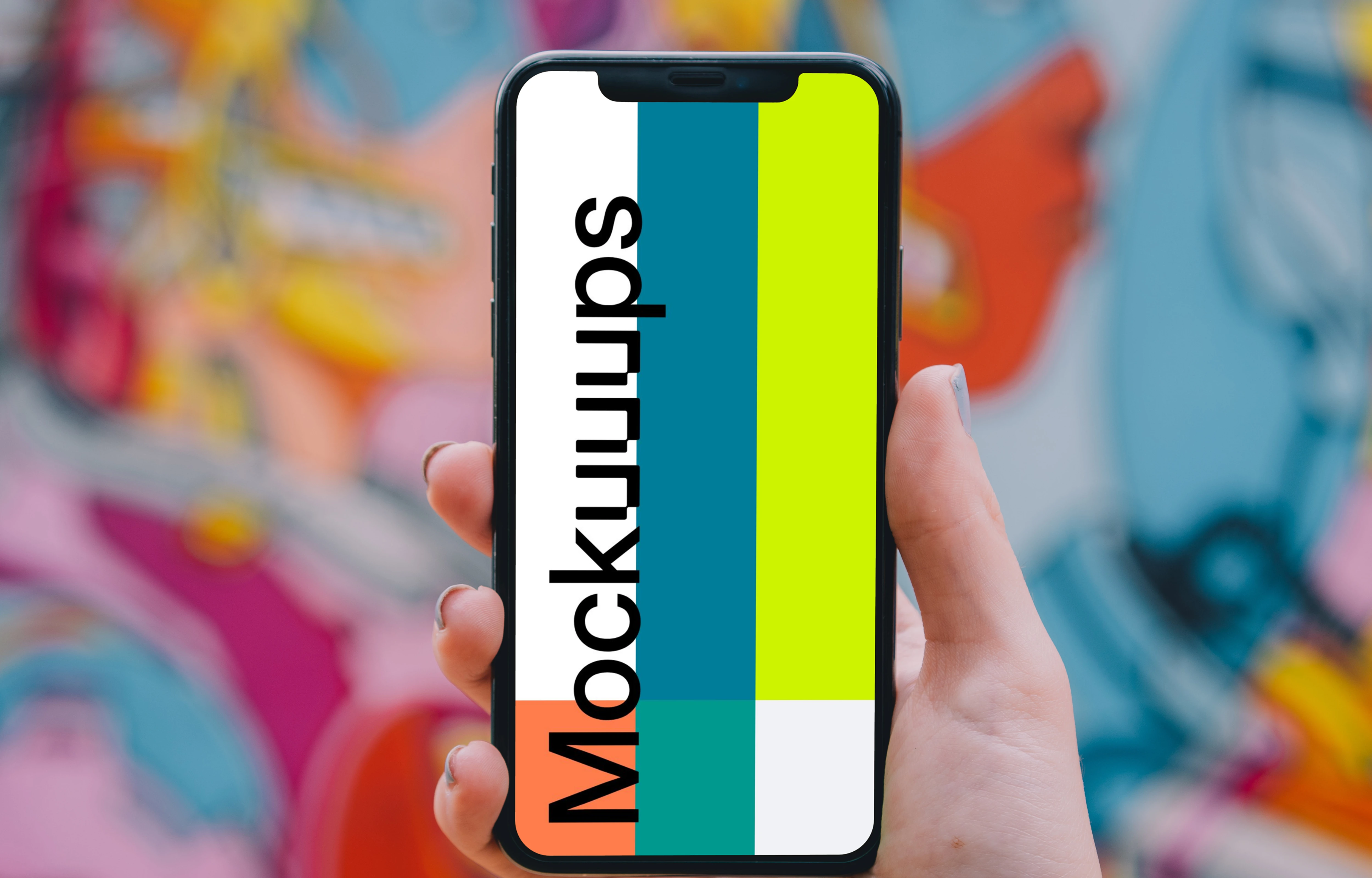 iPhone mockup held in front of graffiti 