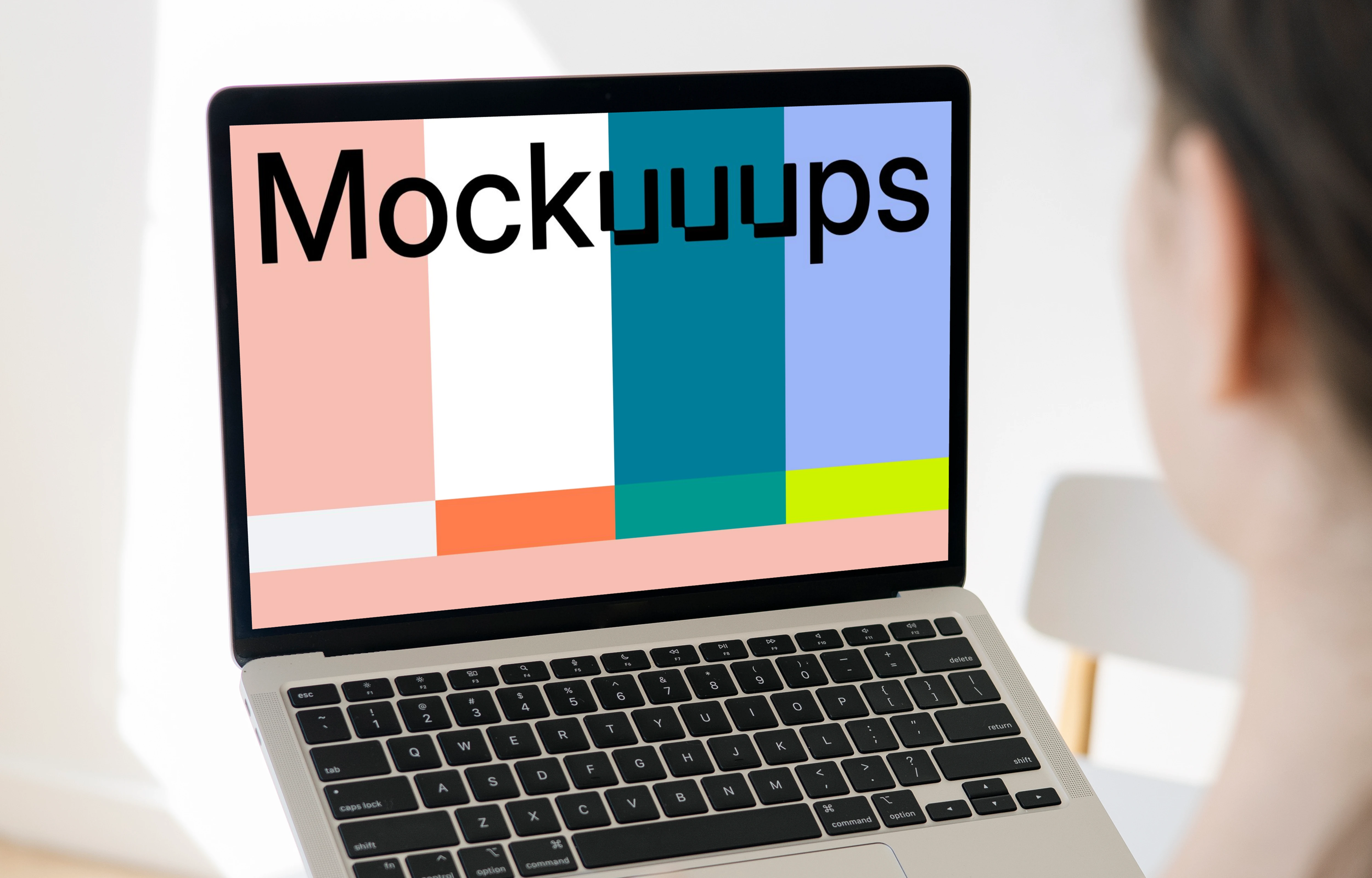 Woman holding a MacBook Pro mockup in a bright room