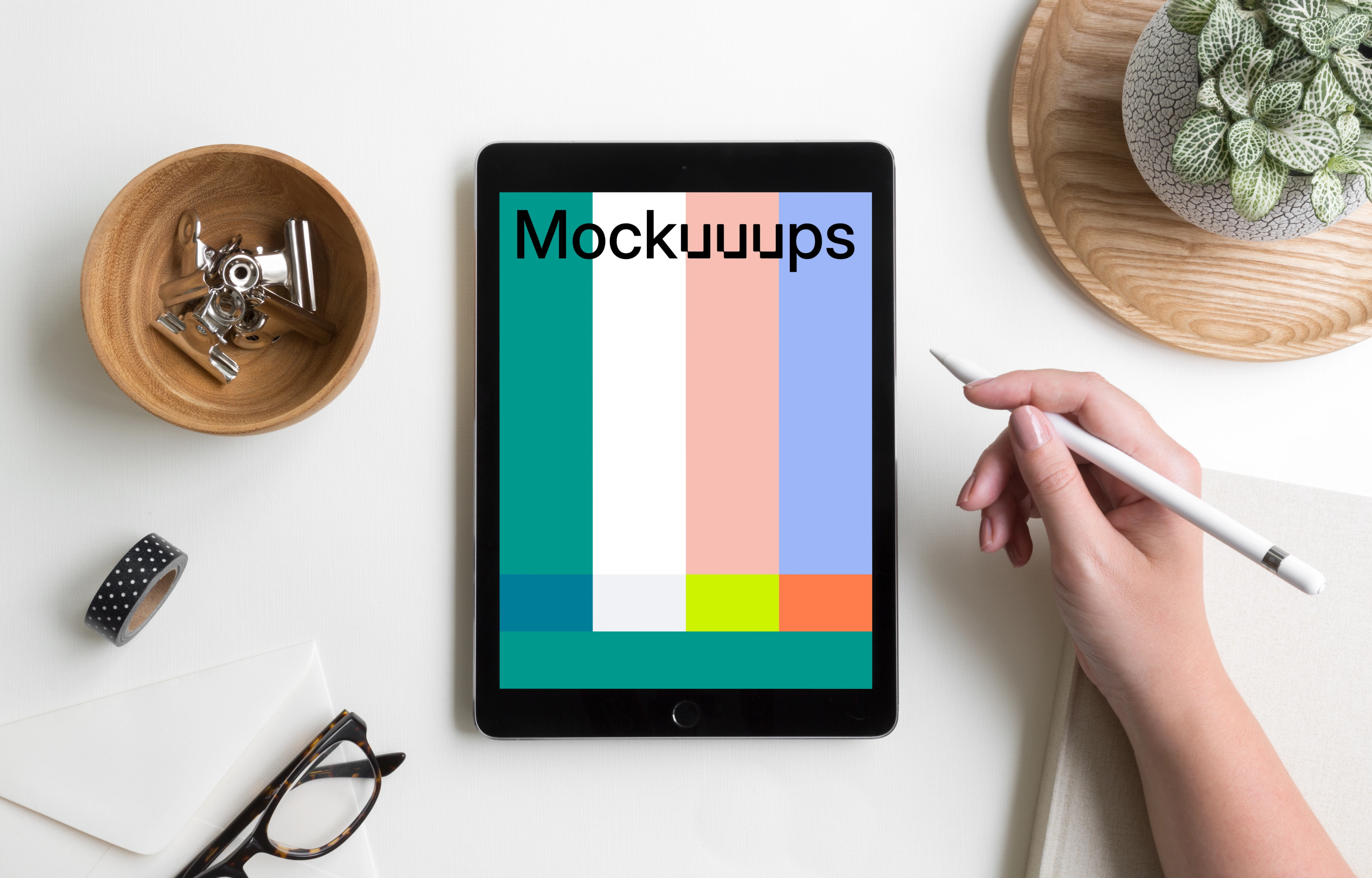 Woman holding Apple pencil over iPad Pro mockup