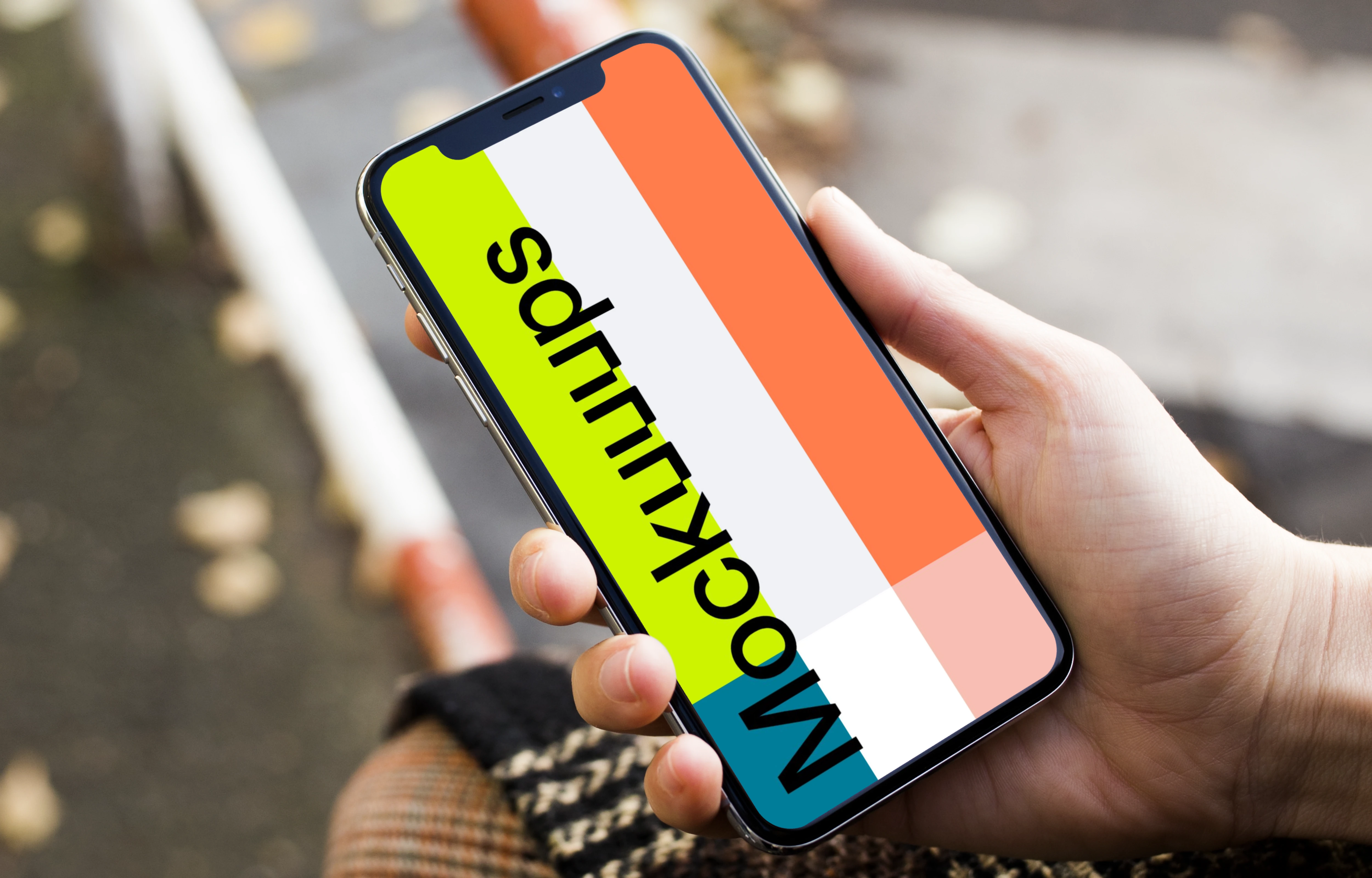 Woman sitting and holding iPhone X mockup