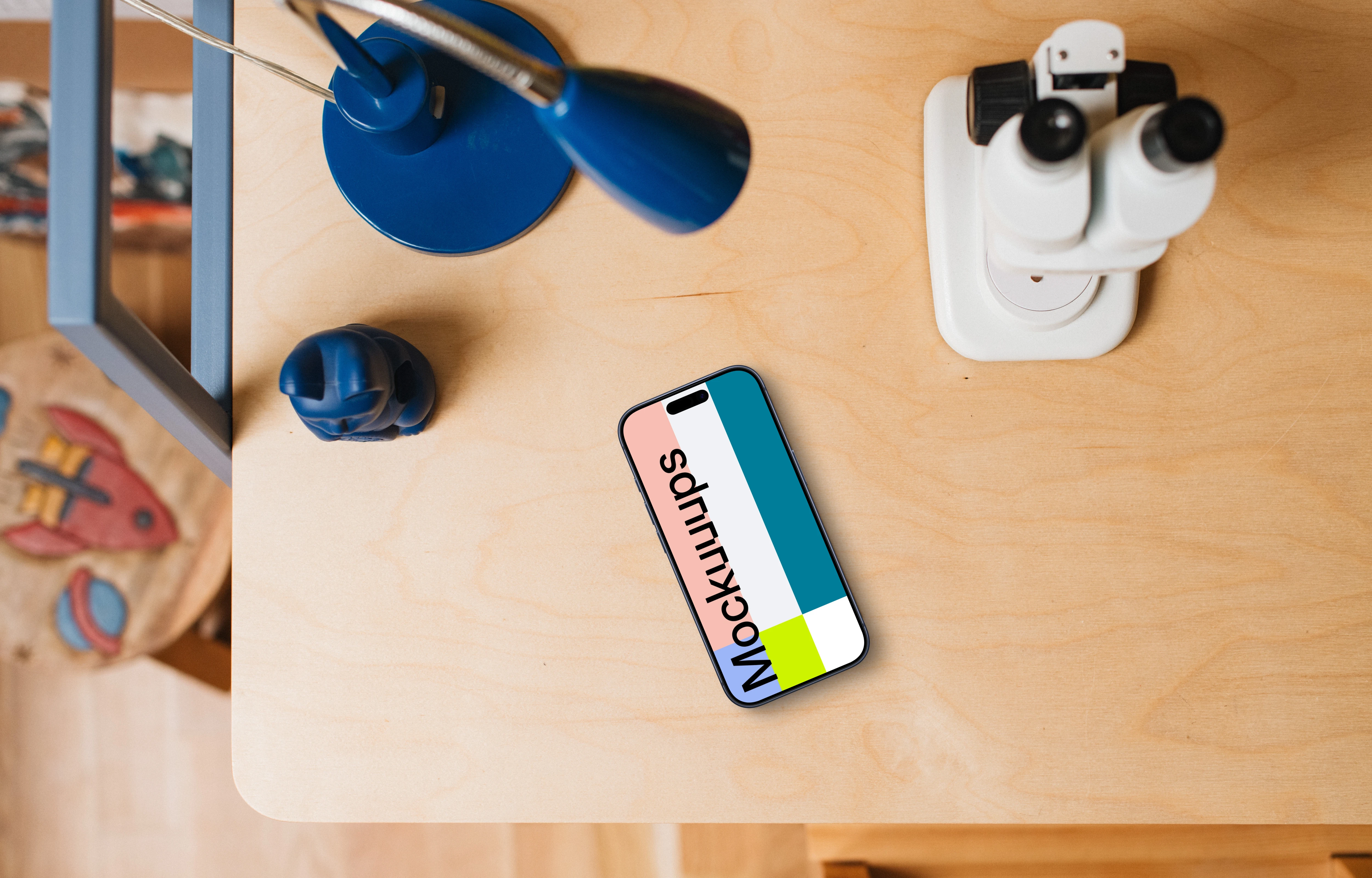 Smartphone mockup on a child's creative table