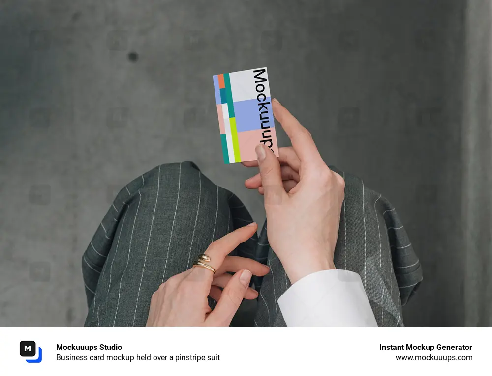Business card mockup held over a pinstripe suit