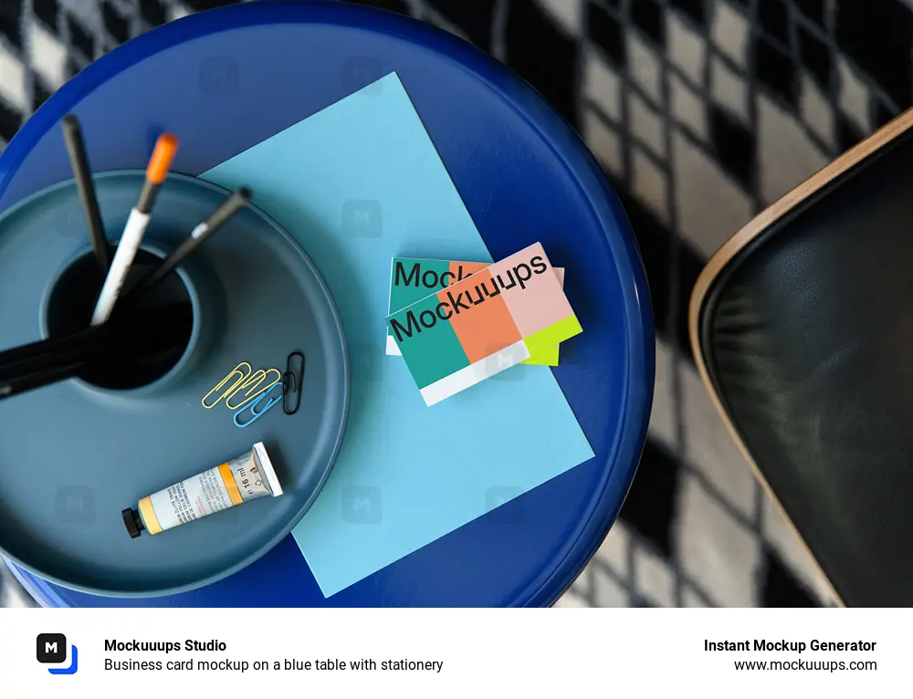 Business card mockup on a blue table with stationery