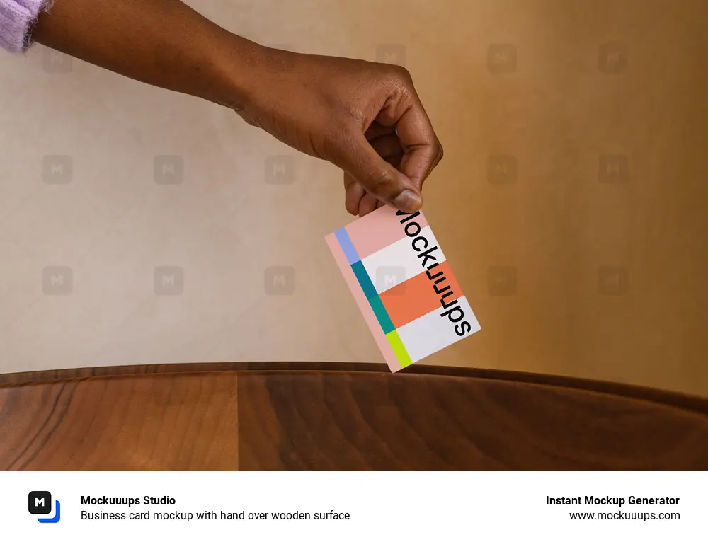 Business card mockup with hand over wooden surface