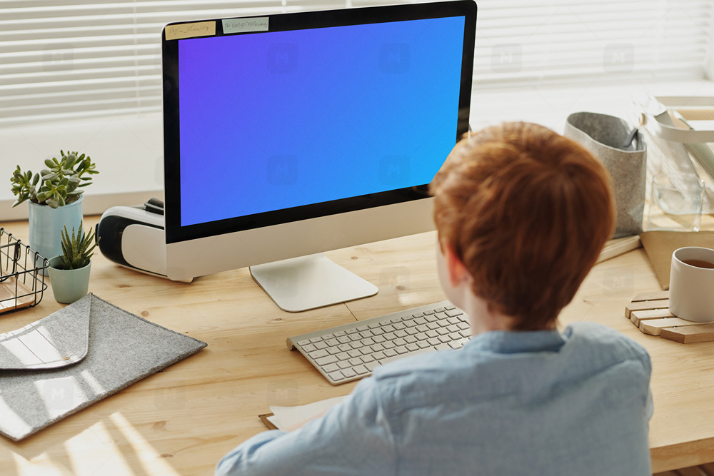 Child working on iMac mockup