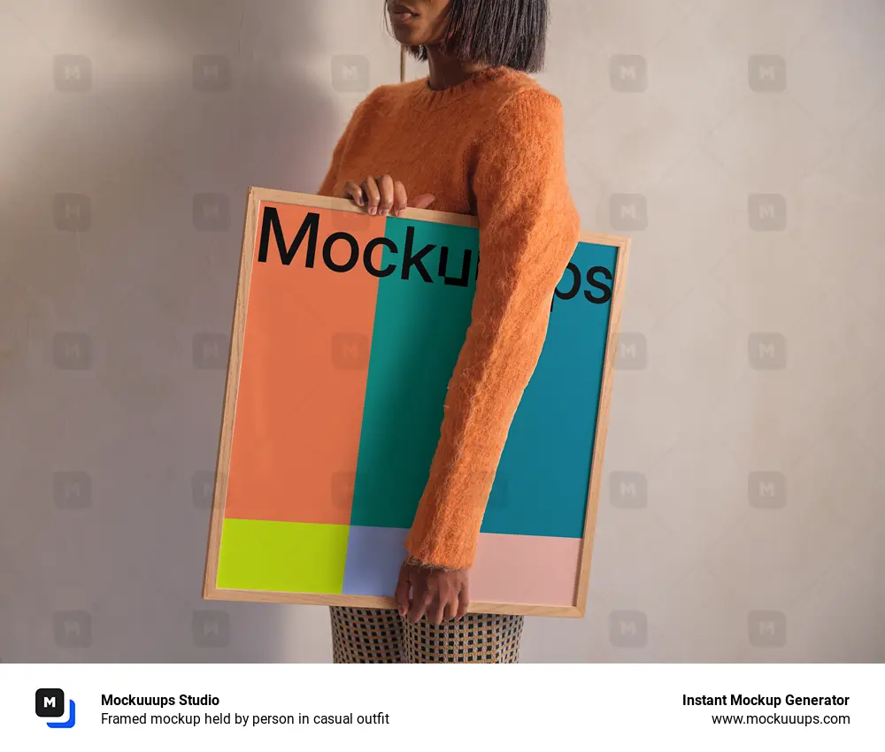 Framed mockup held by person in casual outfit
