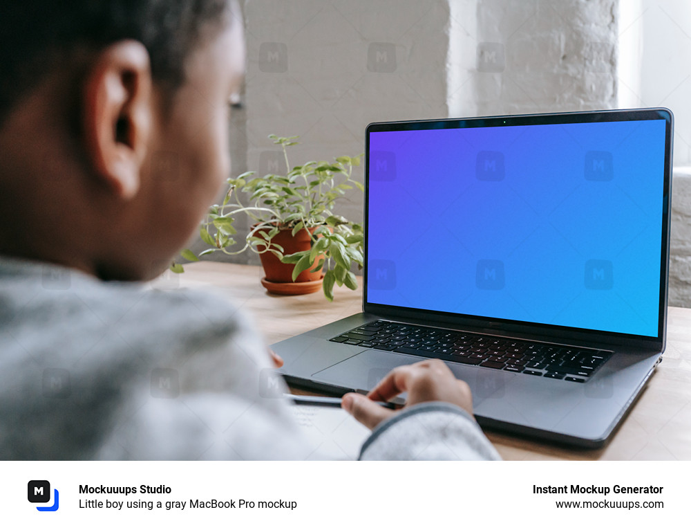 Little boy using a gray MacBook Pro mockup