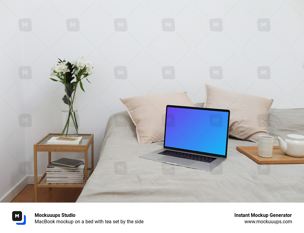 MacBook mockup on a bed with tea set by the side
