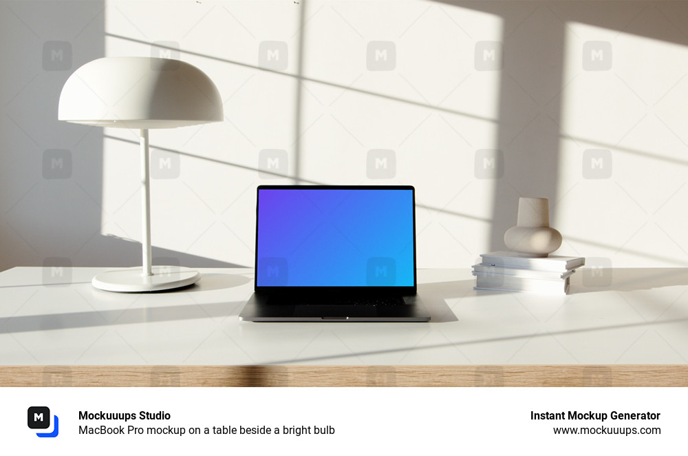 MacBook Pro mockup on a table beside a bright bulb