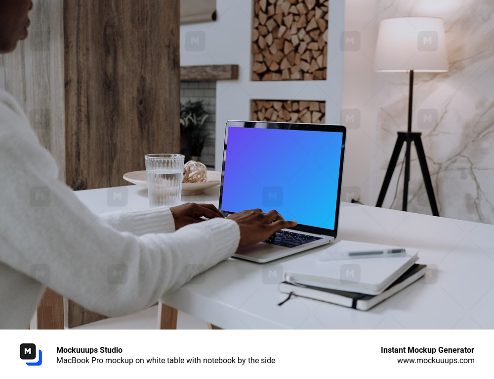 MacBook Pro mockup on white table with notebook by the side