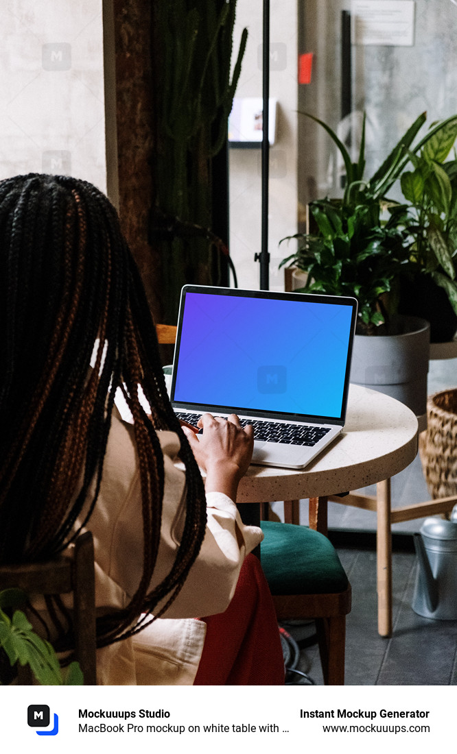 MacBook Pro mockup on white table with notebook by the side