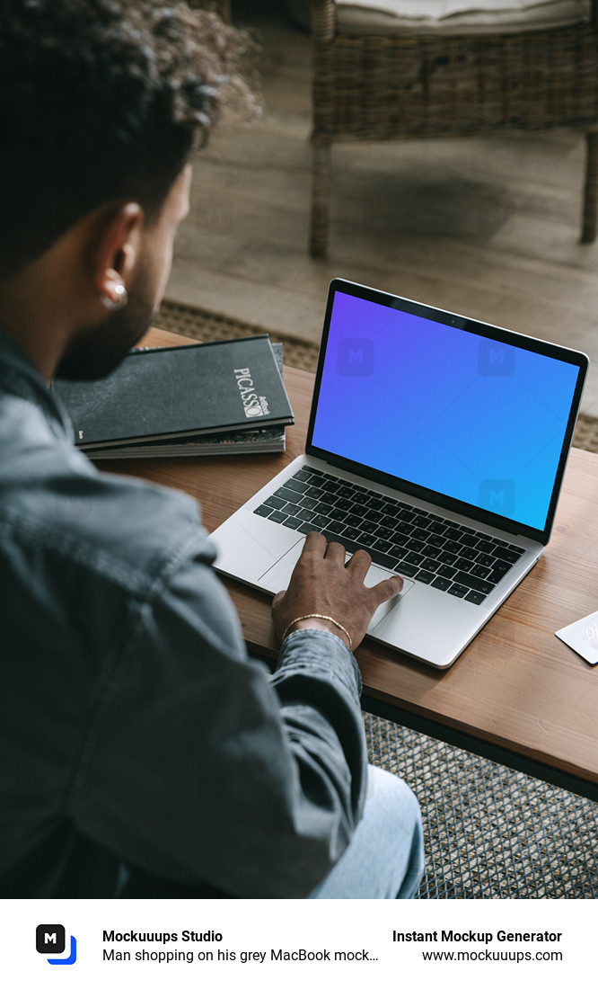 Man shopping on his grey MacBook mockup  