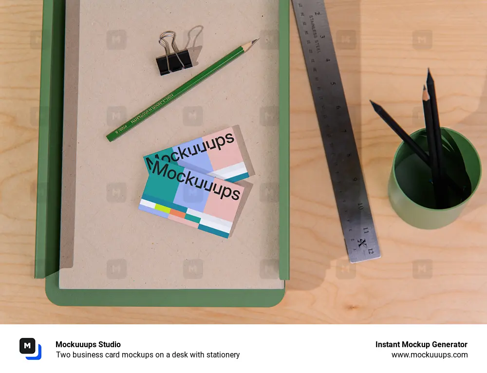 Two business card mockups on a desk with stationery