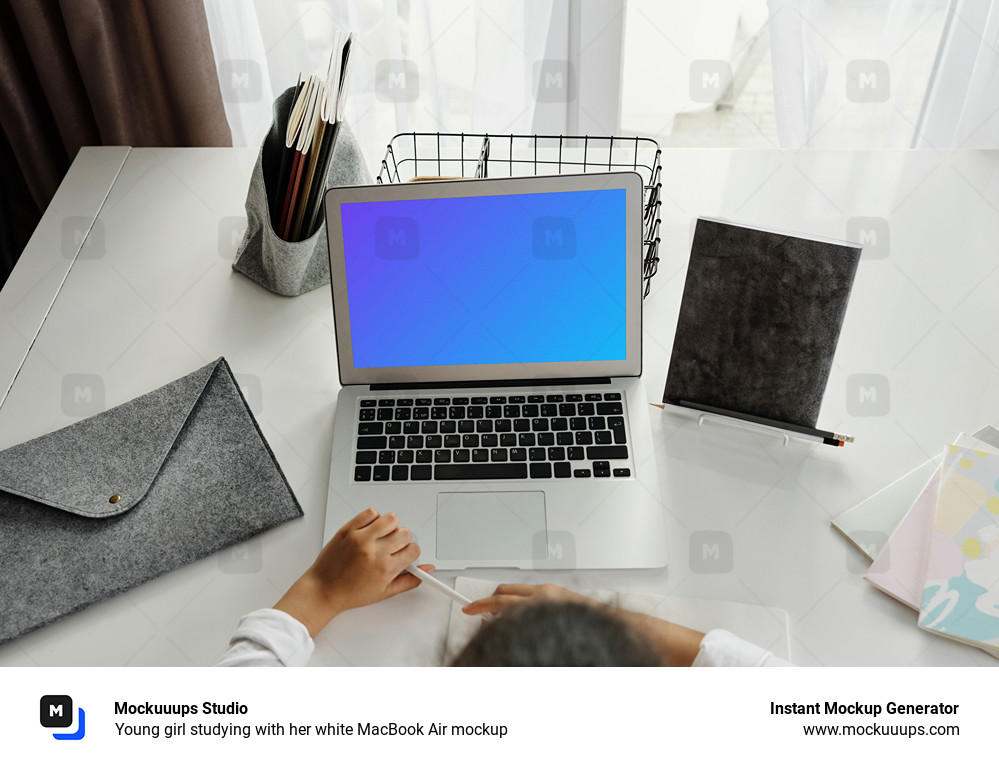 Young girl studying with her white MacBook Air mockup