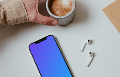 Minimal iPhone mockup on a table with a pair of Airpods and a cup of coffee