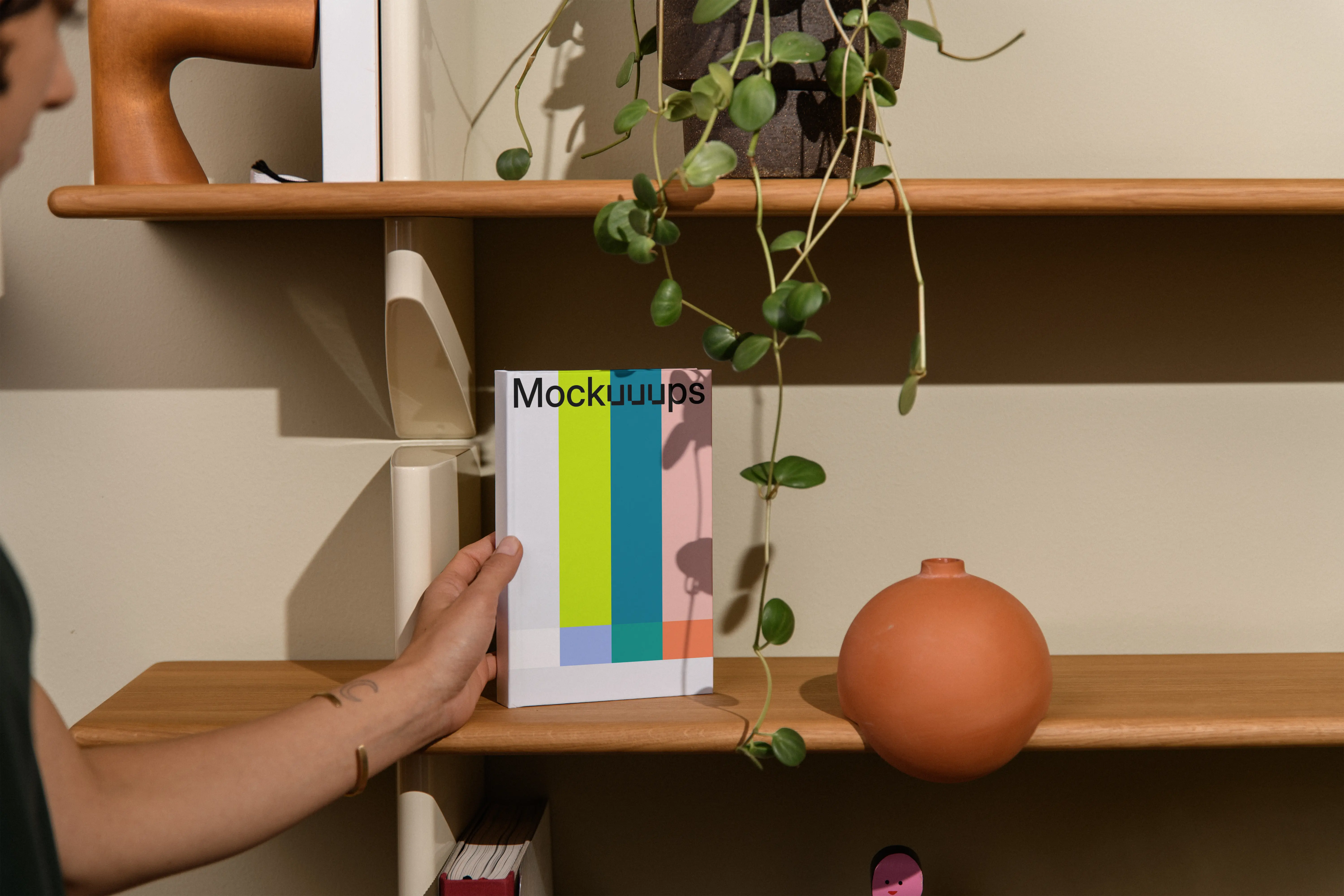 B-format book mockup on a wooden shelf with decor