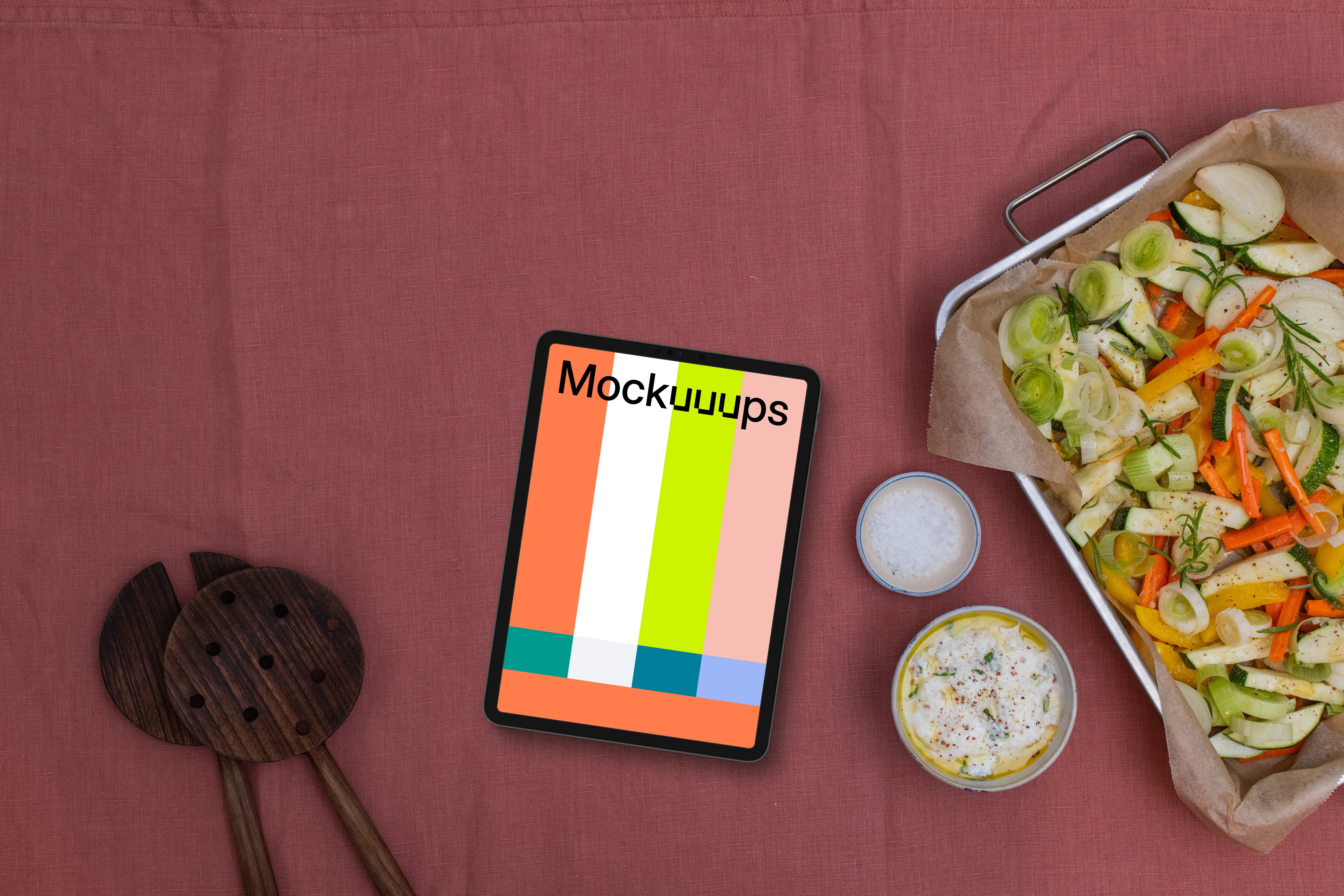 Baking pan full of vegetables and a tablet mockup