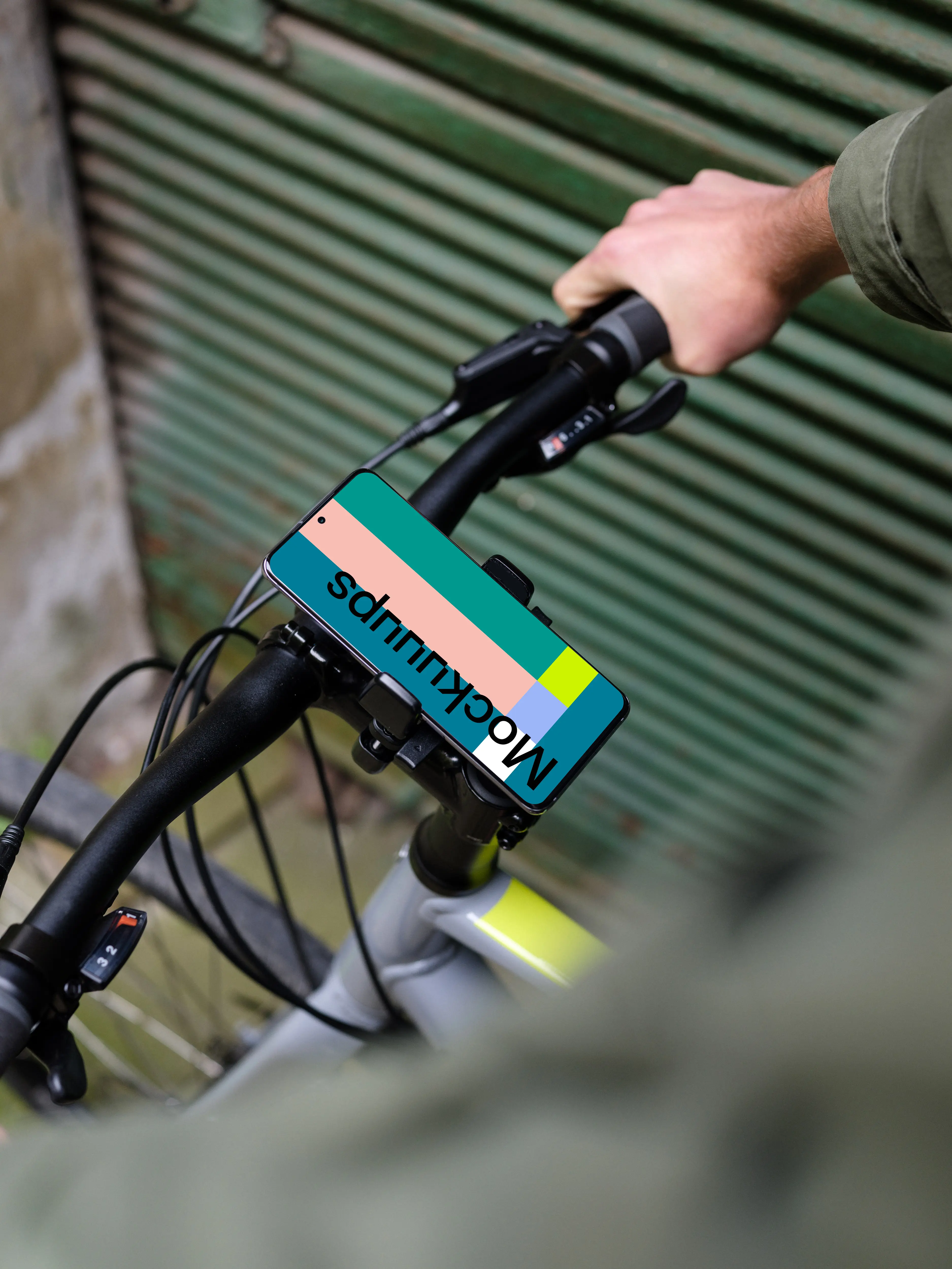 Bike next to a garage door with Samsung S20 mockup in bike mount