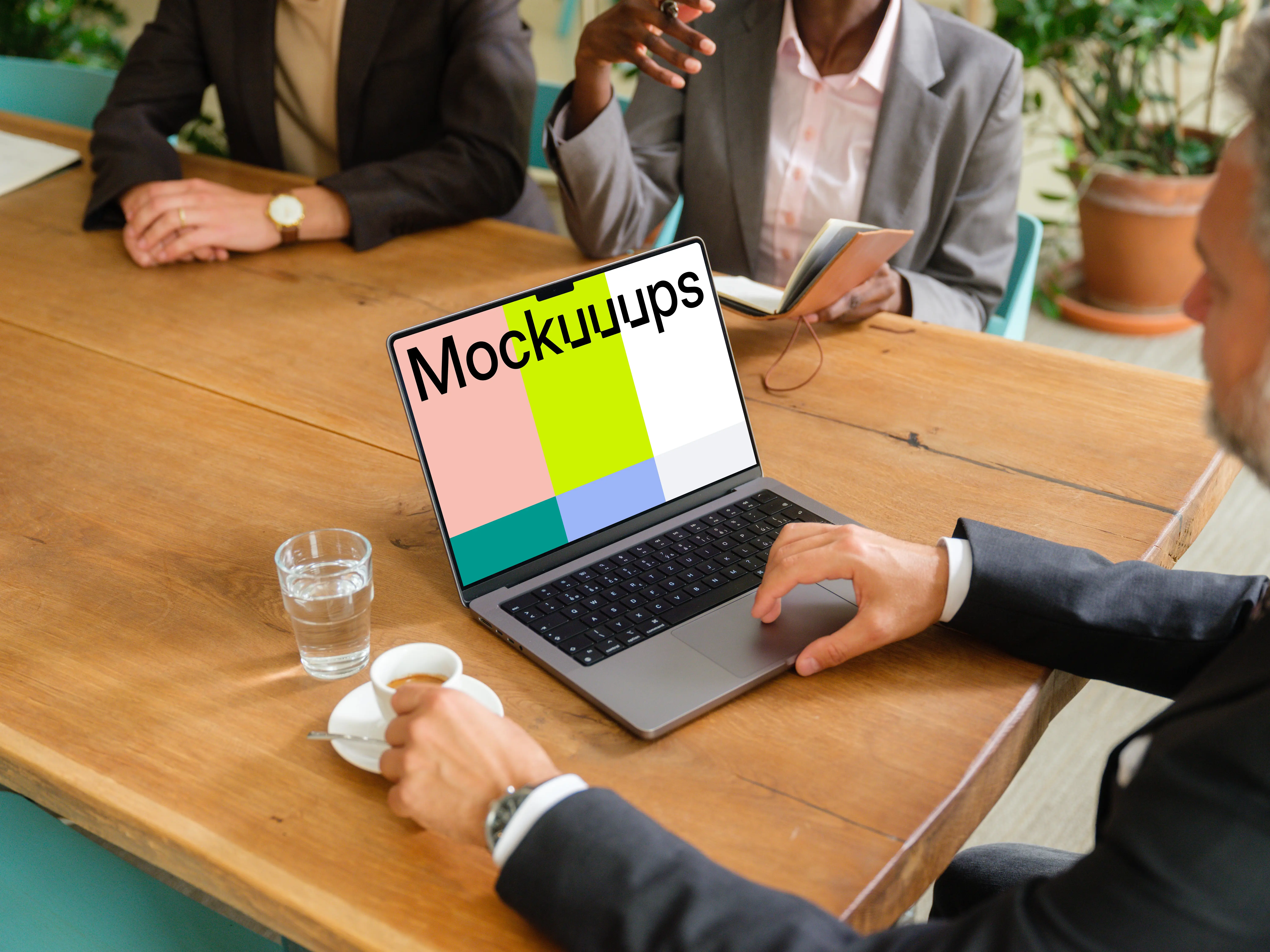 Businessman working on a MacBook during business meeting