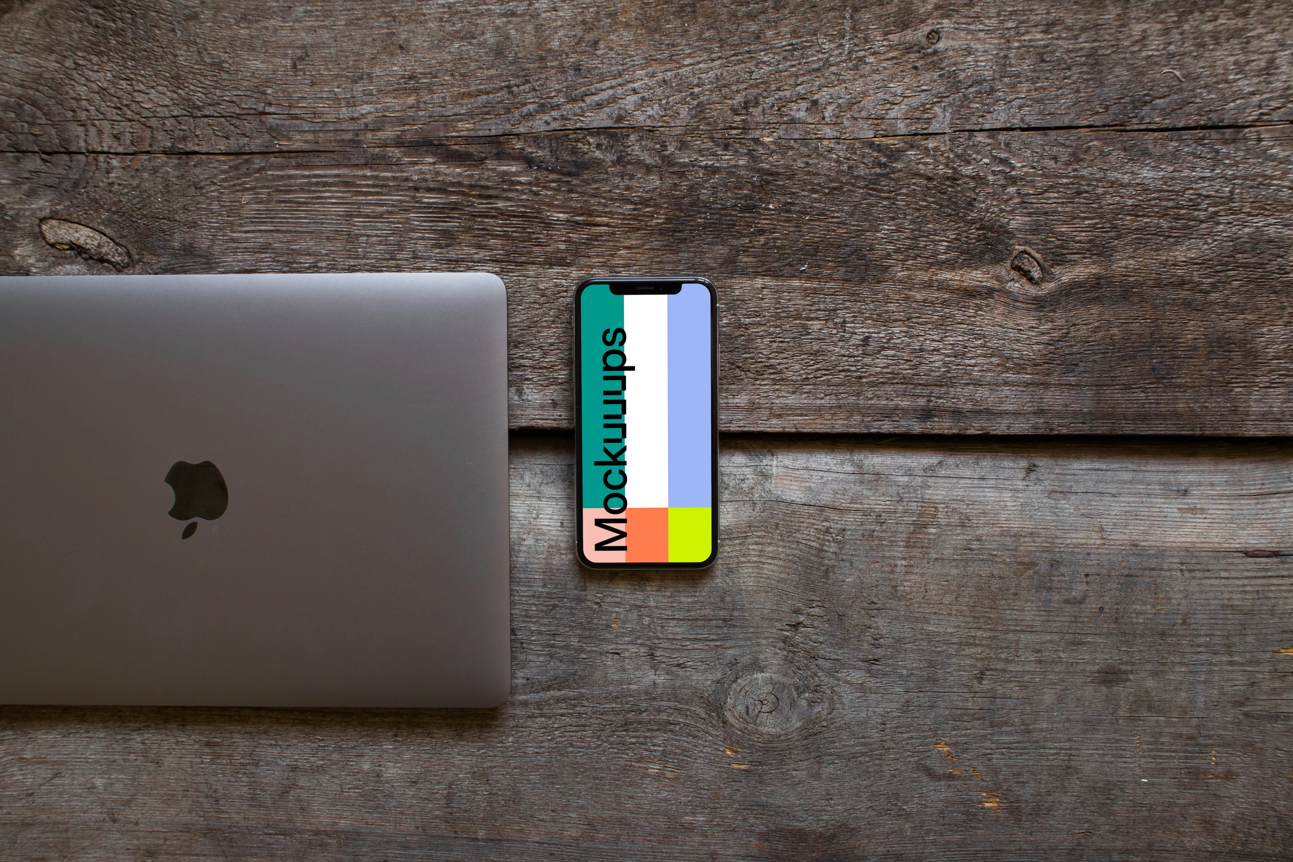 Closed Macbook Air with iPhone XS mockup