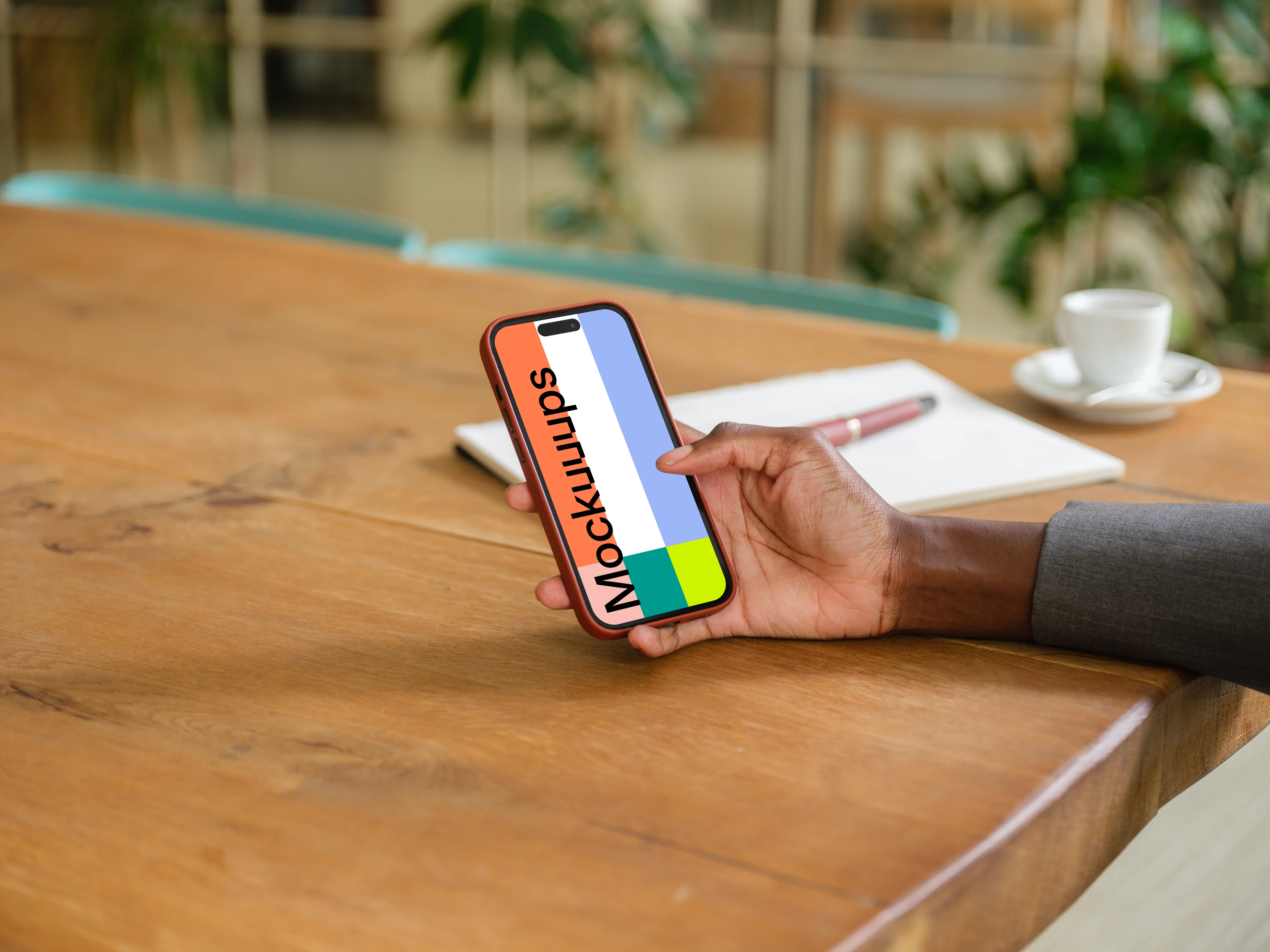 Female entrepreneur in office with iPhone in her hand