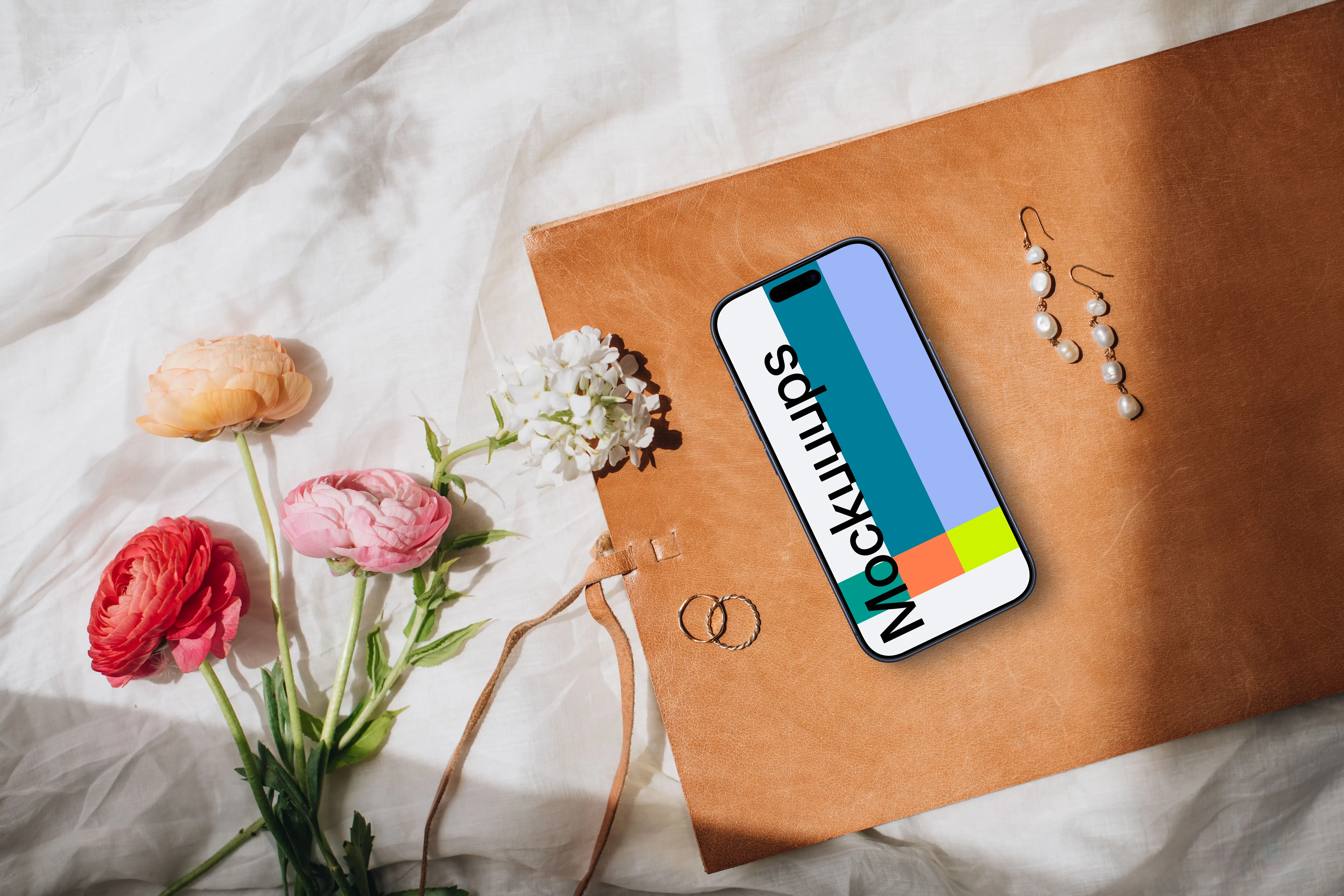 Flowers, wedding rings and iPhone mockup