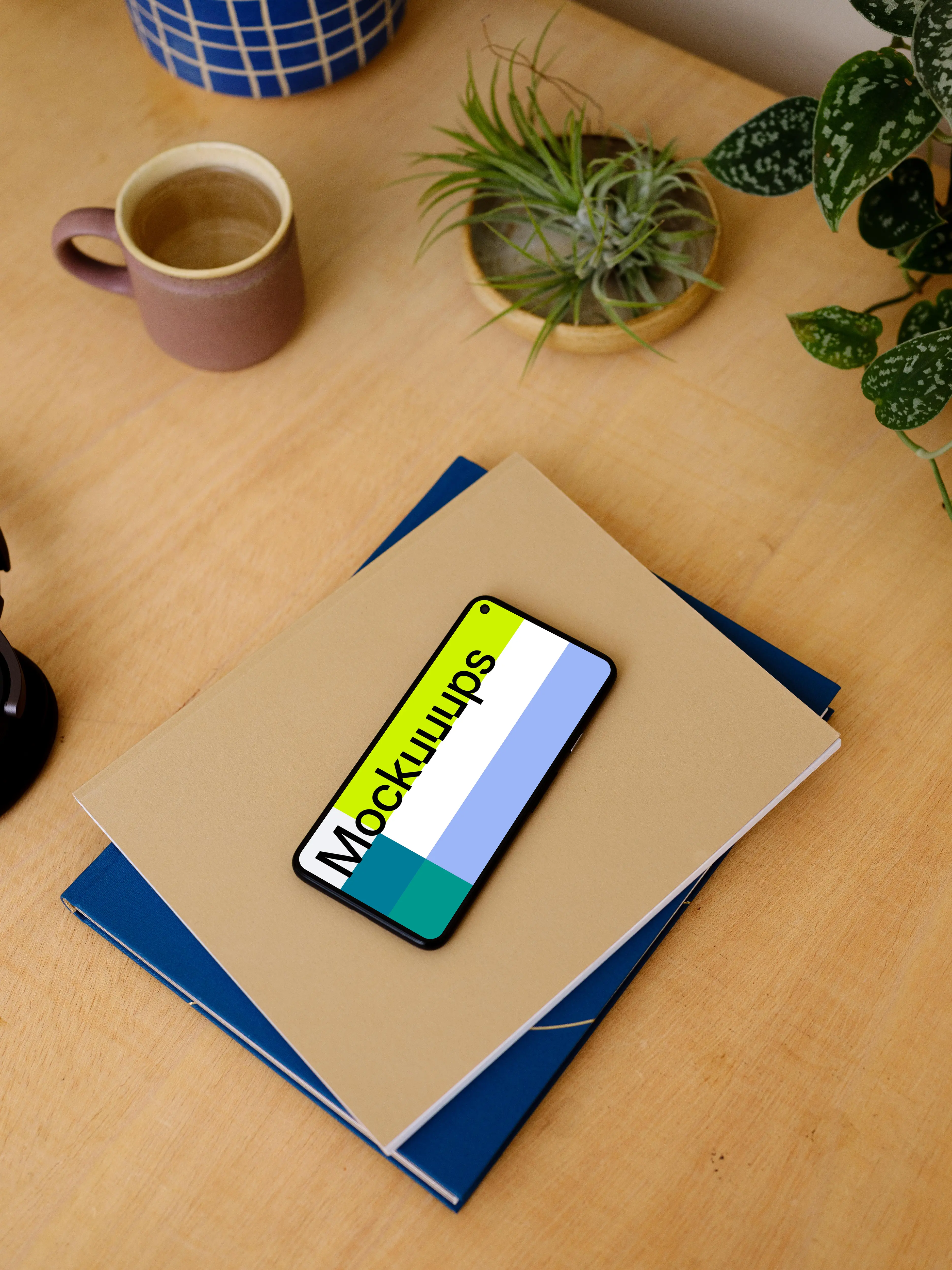 Google Pixel mockup stacked on a pair of notepads