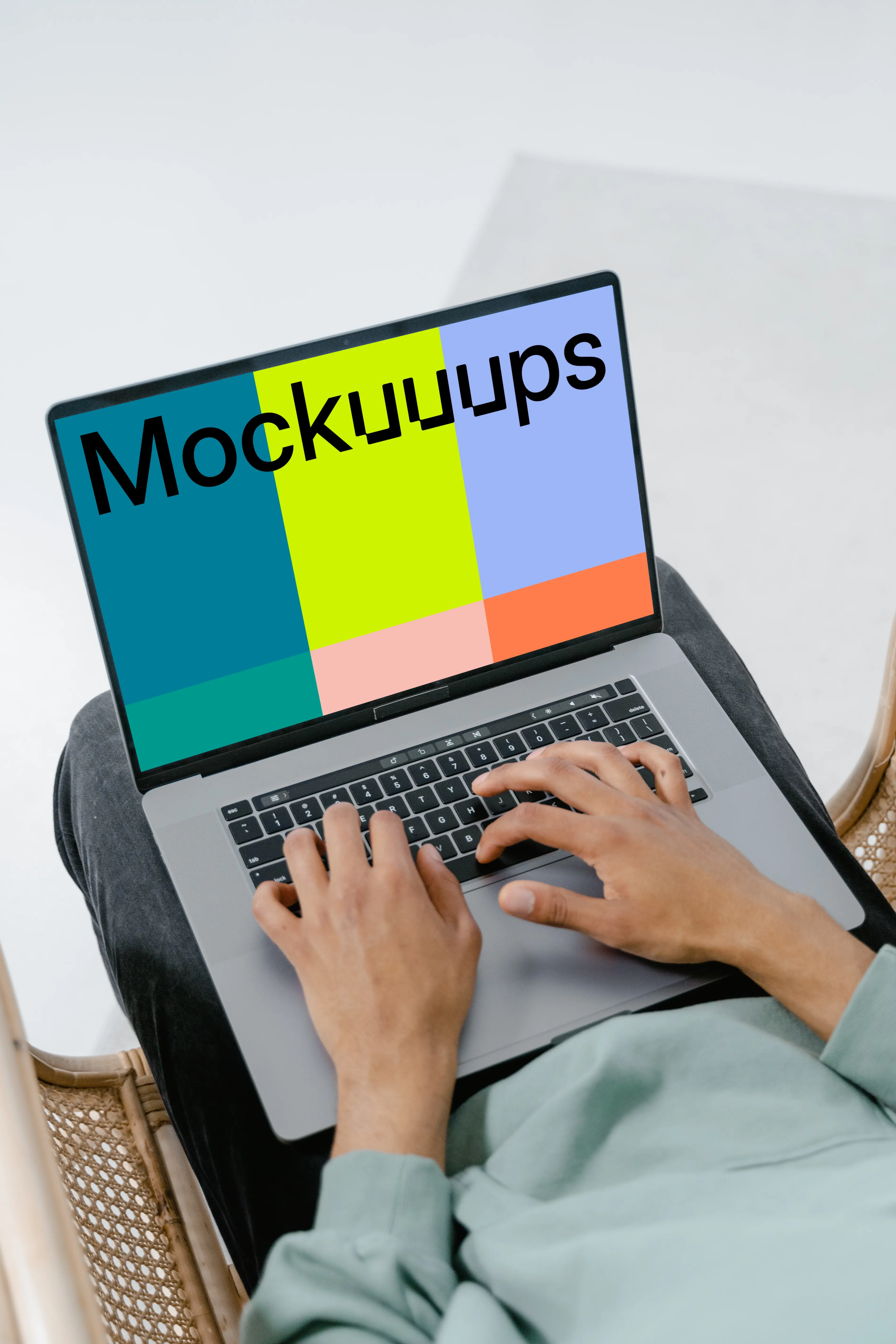 Grey MacBook mockup on a user’s lap