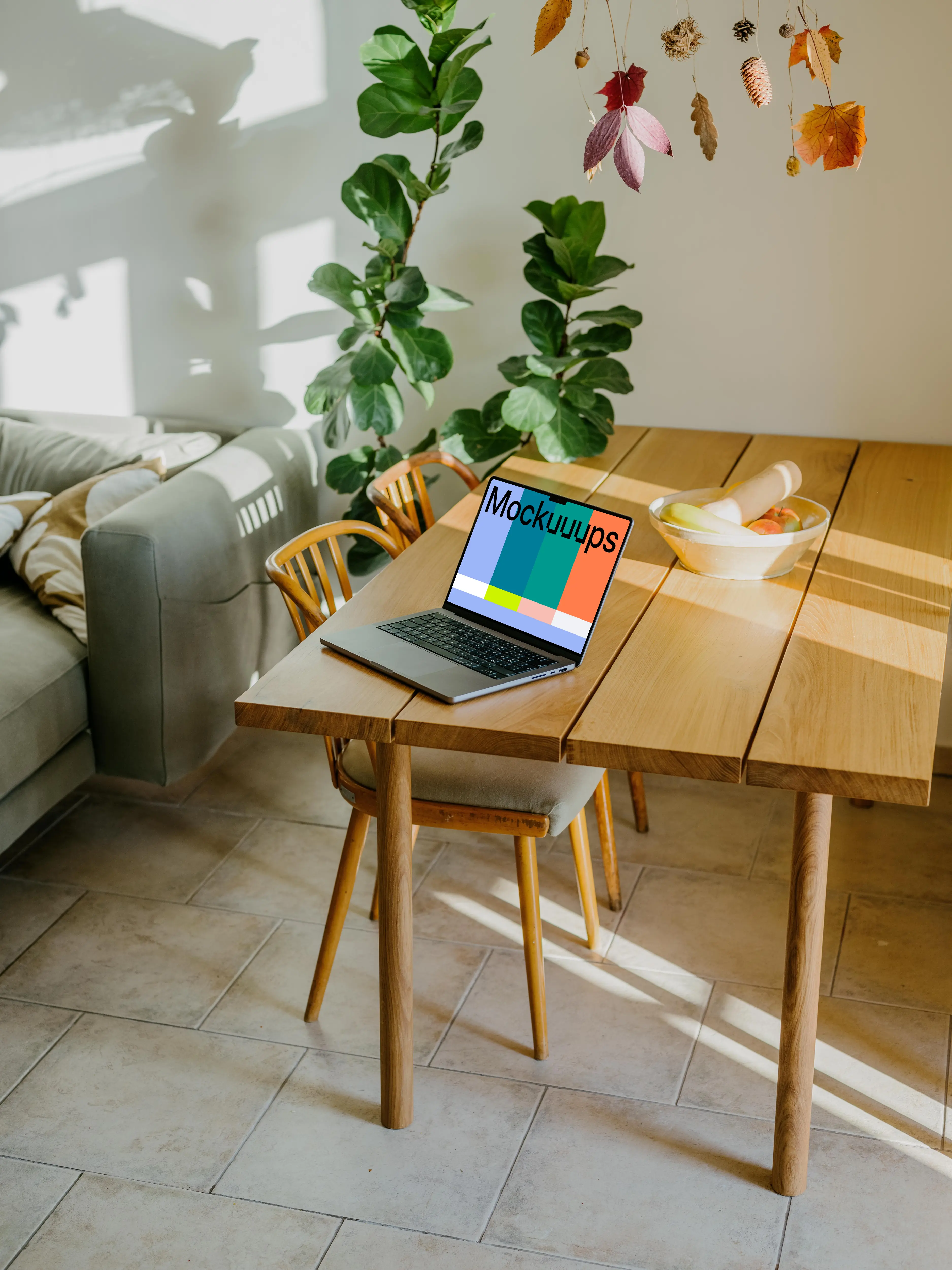 Grey MacBook Pro mockup at the edge of a table